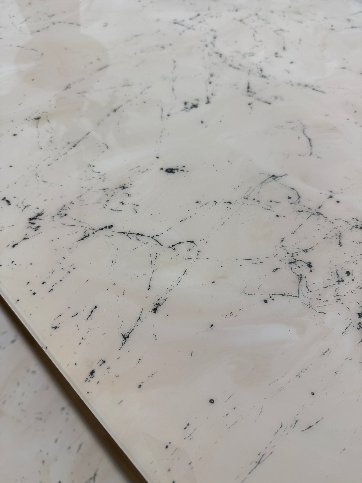 Handmade epoxy resin dining table with artistic marble effect top and custom metal legs – made to order in the UK, optional matching benches available.