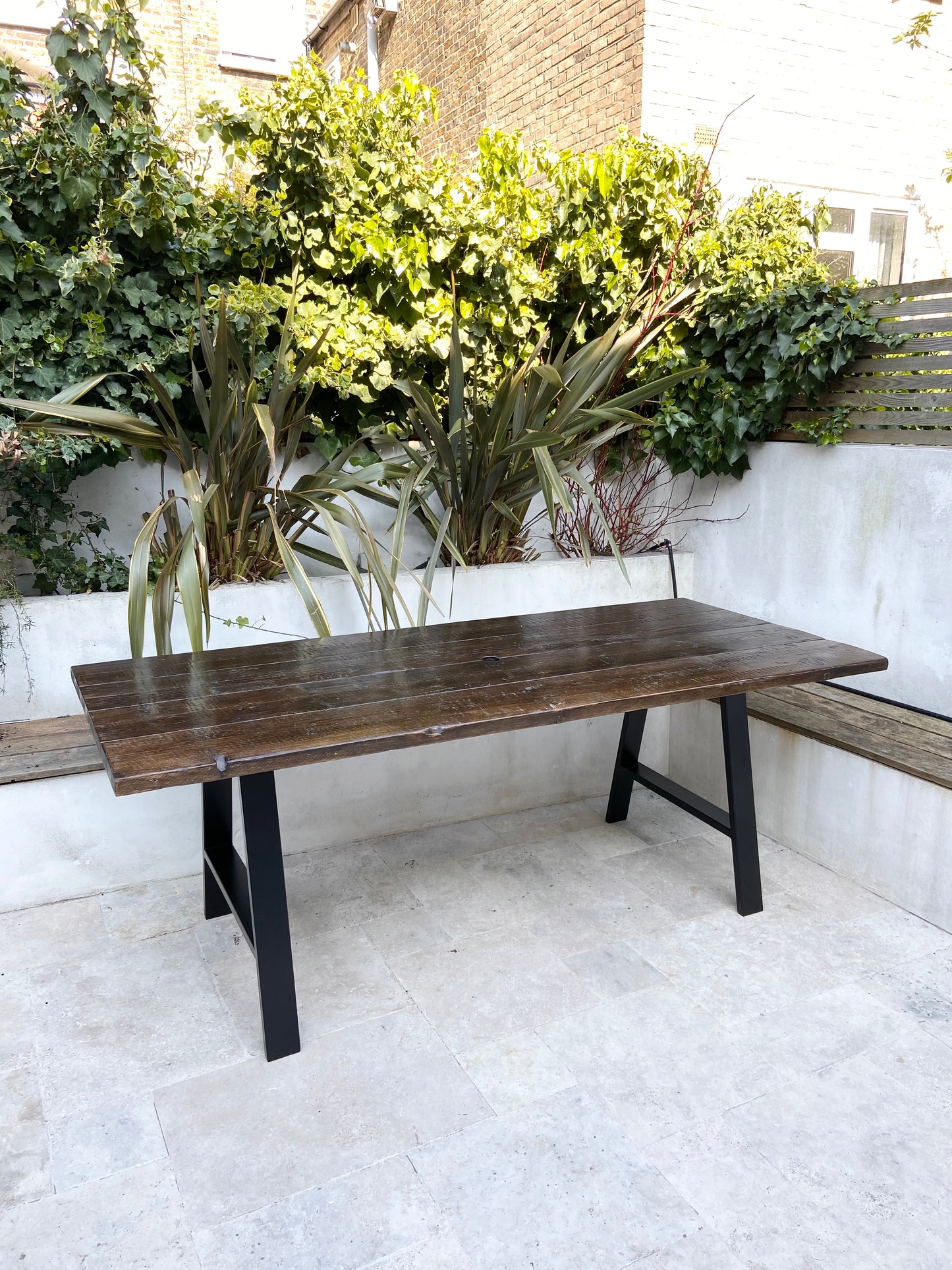 Handcrafted outdoor dining table made from reclaimed scaffold boards