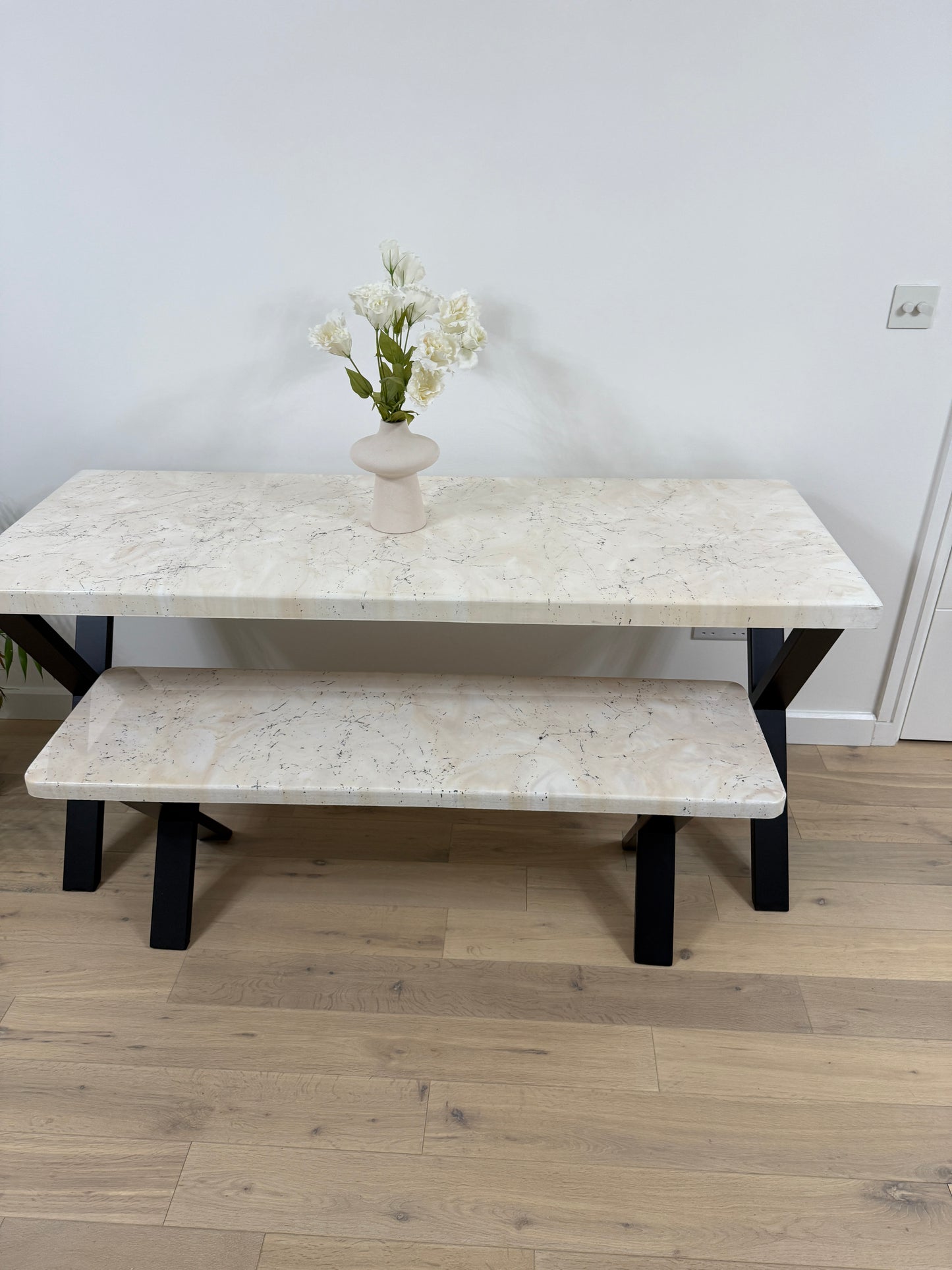 Handmade epoxy resin dining table with artistic marble effect top and custom metal legs – made to order in the UK, optional matching benches available.