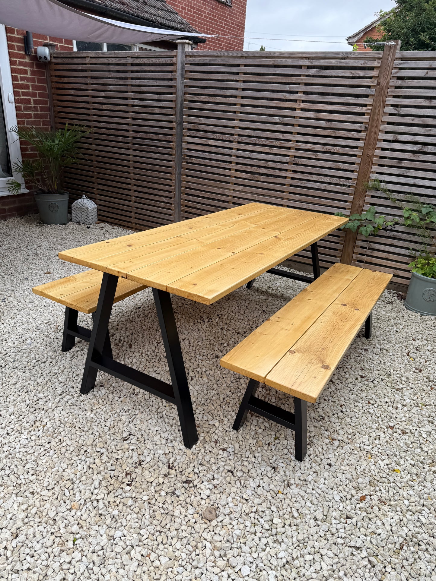 Handcrafted outdoor dining table made from reclaimed scaffold boards