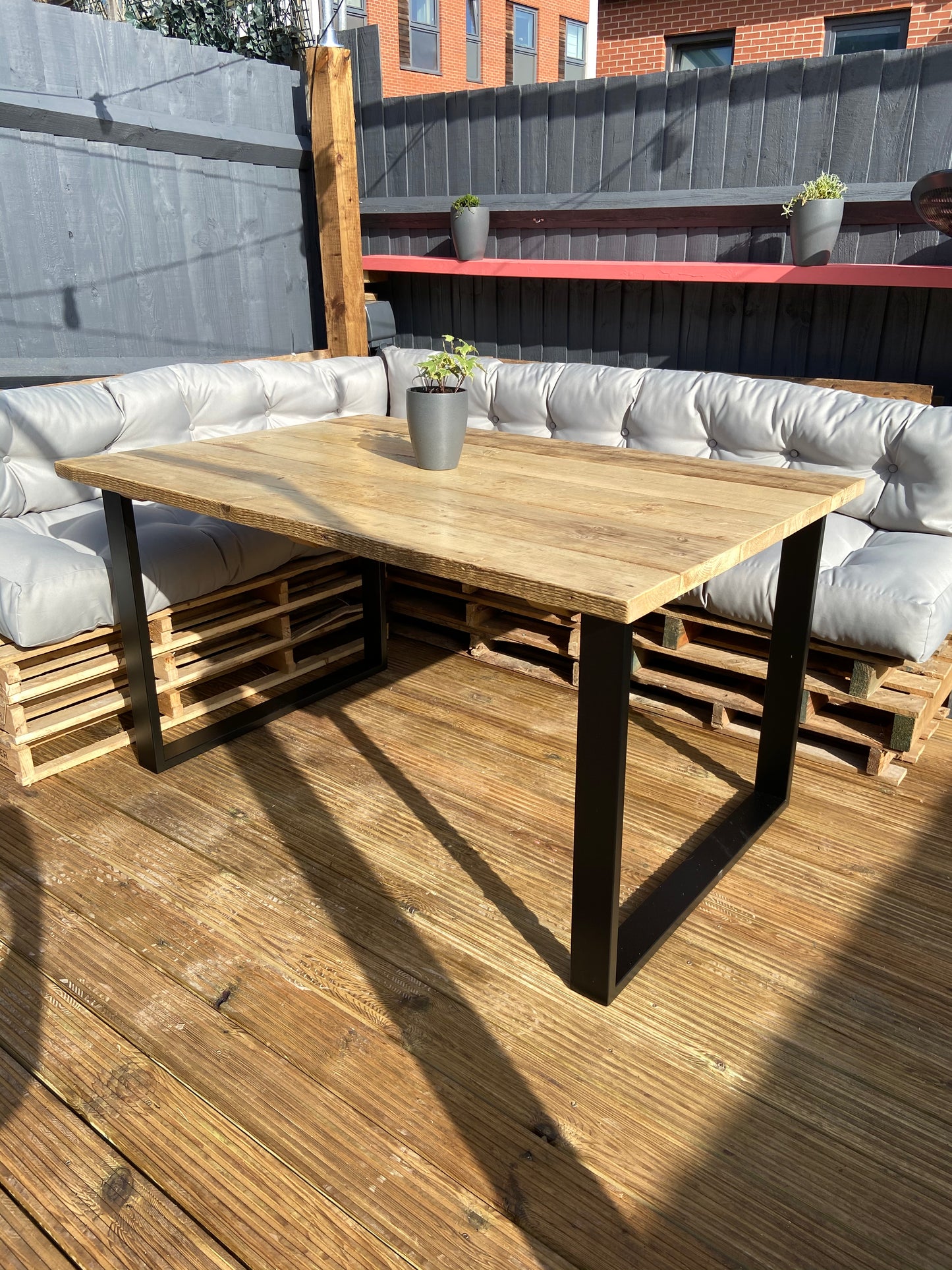 Handcrafted outdoor dining table made from reclaimed scaffold boards