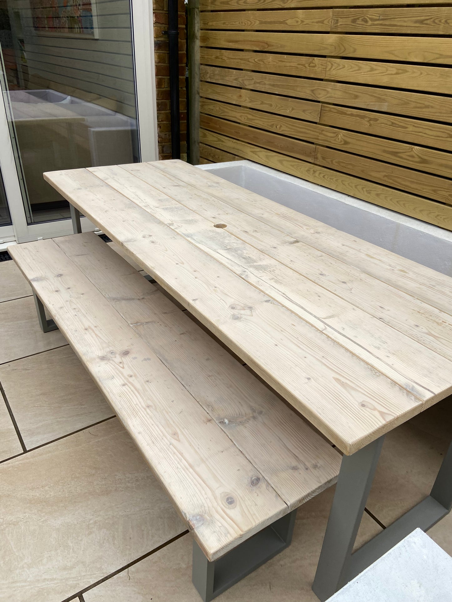 Handcrafted outdoor dining table made from reclaimed scaffold boards