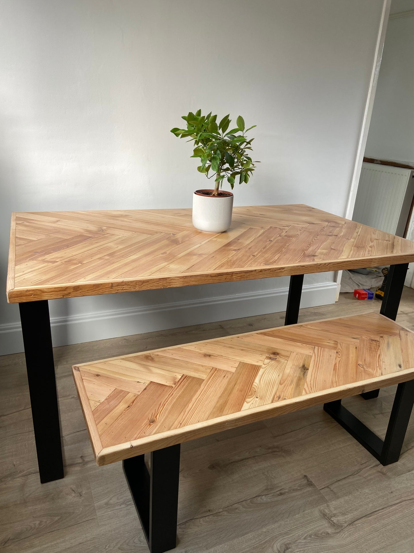Handmade herringbone table crafted from reclaimed wood with metal legs, made to order in the UK