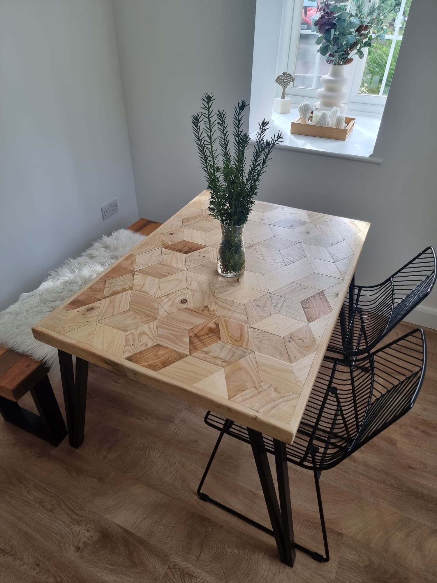 Handcrafted 3D reclaimed wood dining table with unique random pattern top, natural wax finish, and rustic character details like saw marks and paint traces