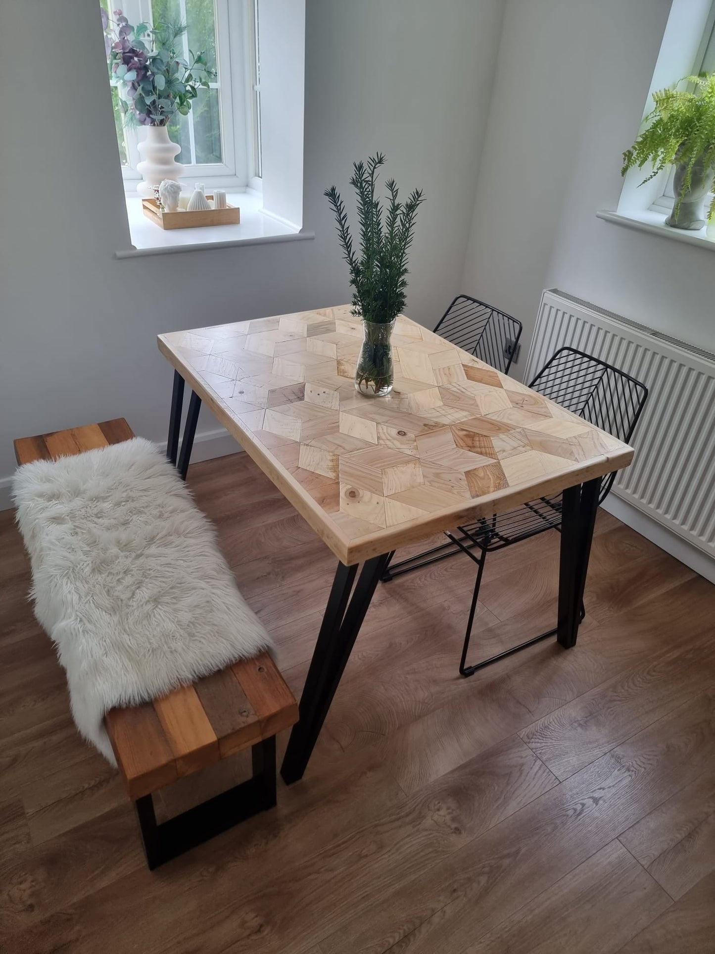 Handcrafted 3D reclaimed wood dining table with unique random pattern top, natural wax finish, and rustic character details like saw marks and paint traces