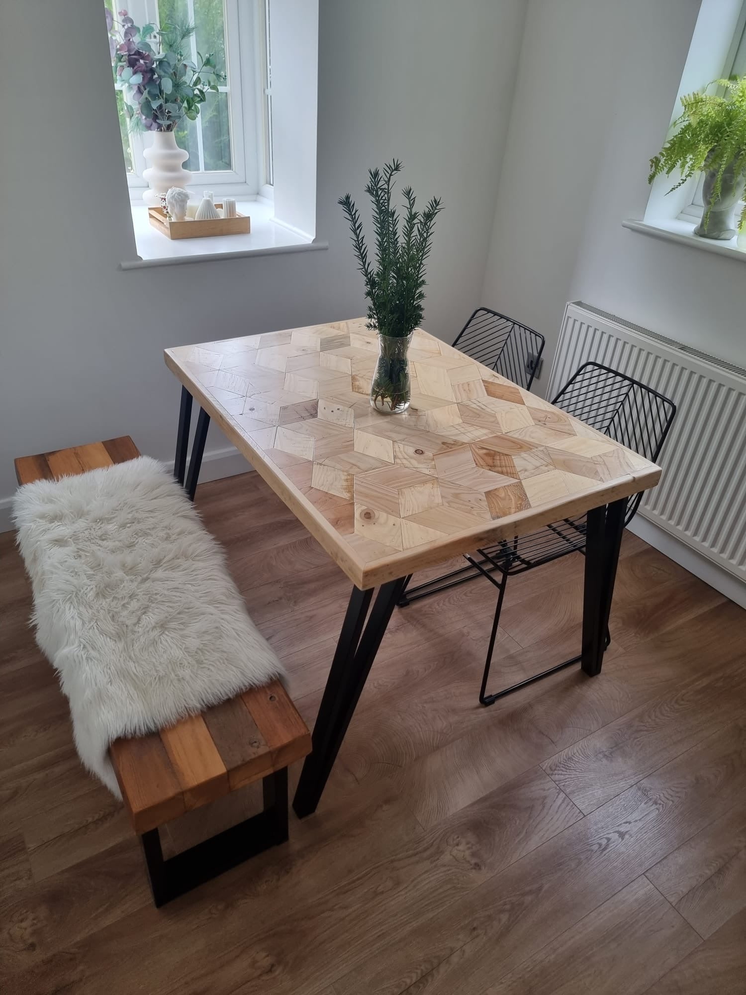 Handcrafted 3D reclaimed wood dining table with unique random pattern top, natural wax finish, and rustic character details like saw marks and paint traces