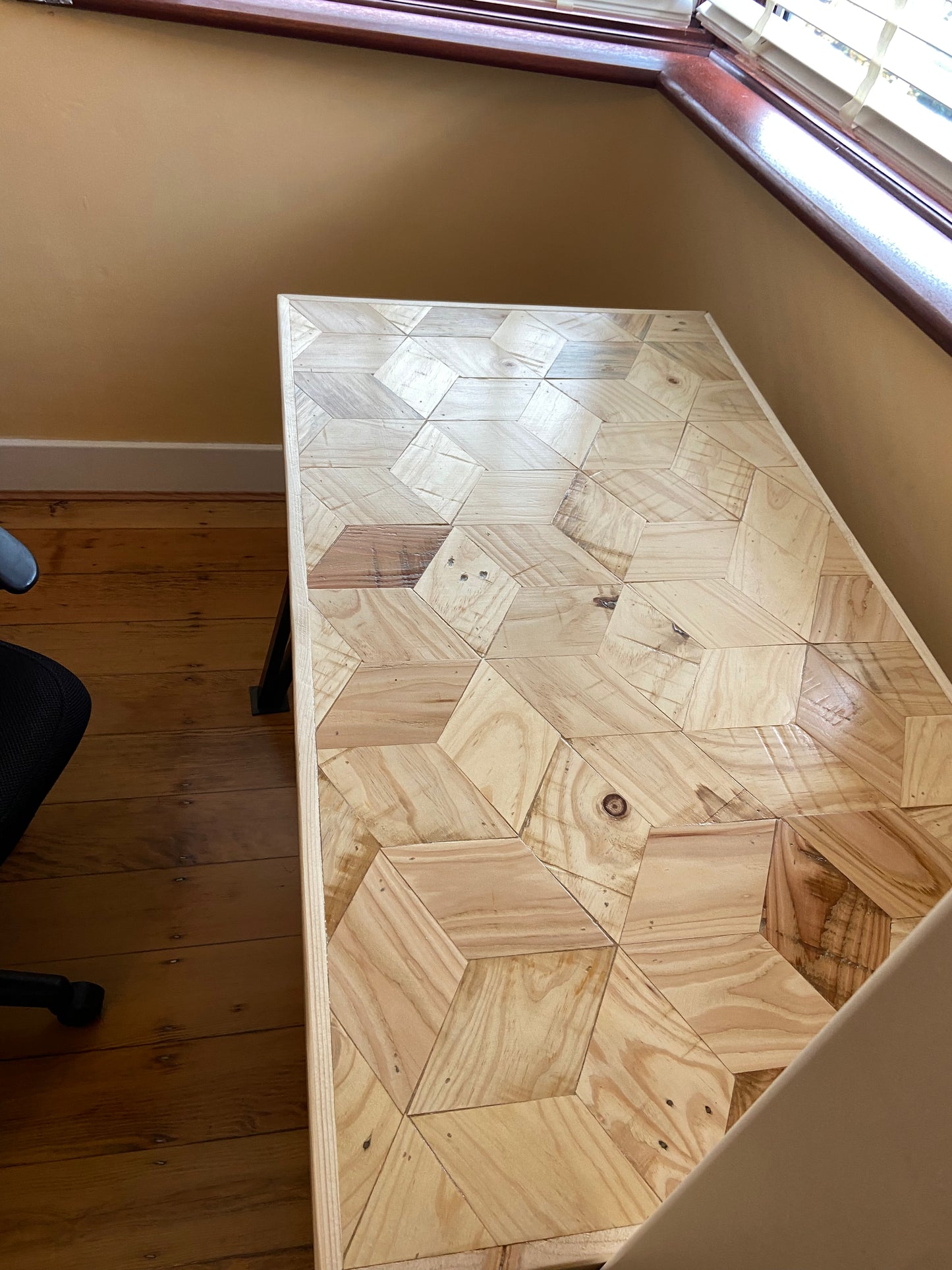 Handmade desk with 3D block pattern top crafted from reclaimed wood and industrial metal legs – sustainable design for home office or studio.