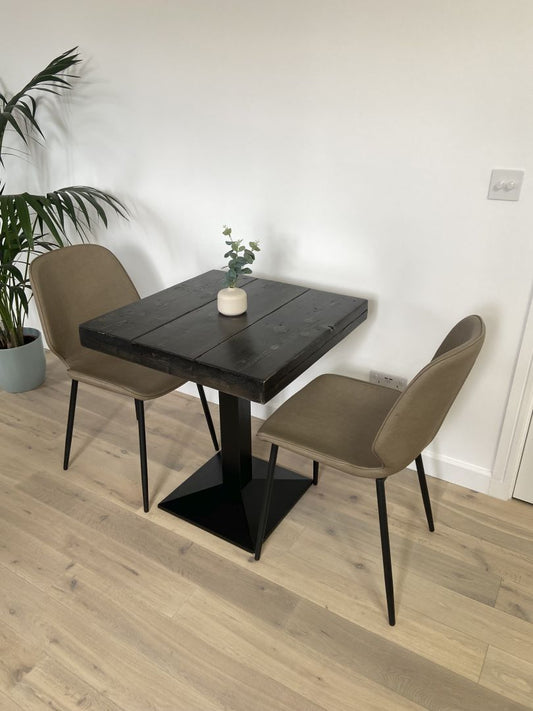 Square bistro table with reclaimed scaffold board top and black cast iron pedestal base, handcrafted in the UK with a smooth wax finish