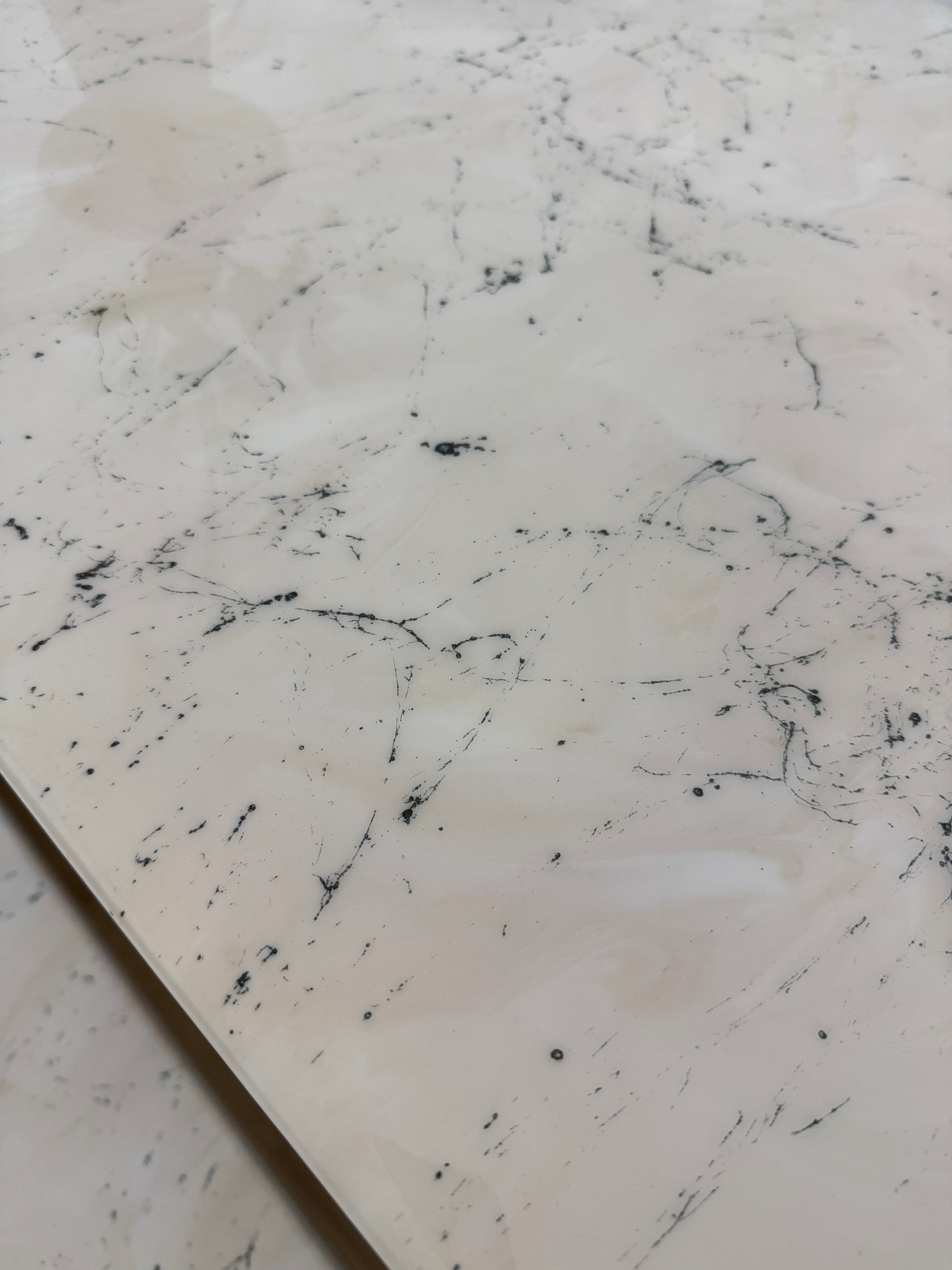 Handmade epoxy resin dining table with artistic marble effect top and custom metal legs – made to order in the UK, optional matching benches available.