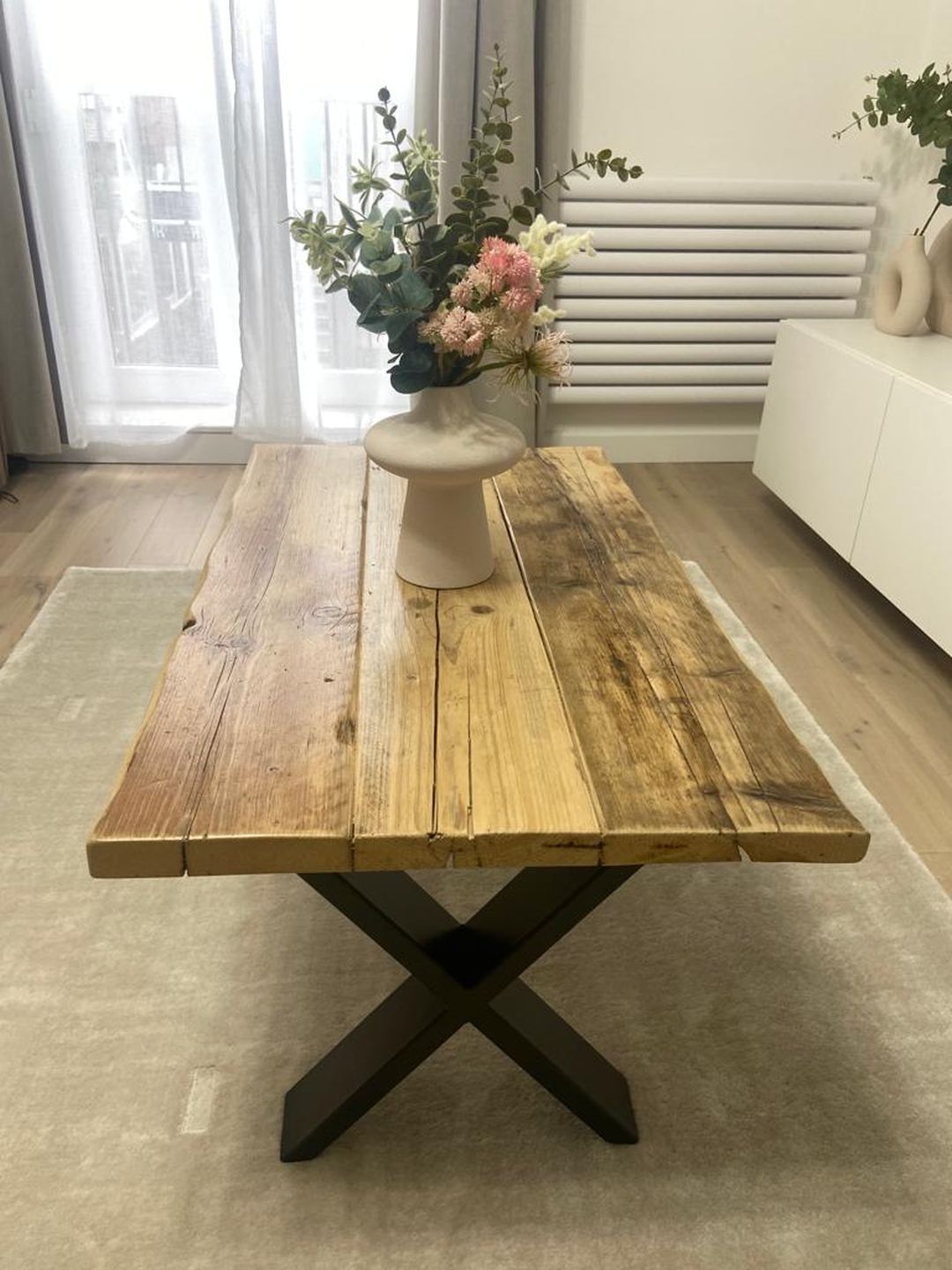 Handmade coffee table crafted from reclaimed scaffold boards with a rustic wood top and metal legs – sustainable and full of character.