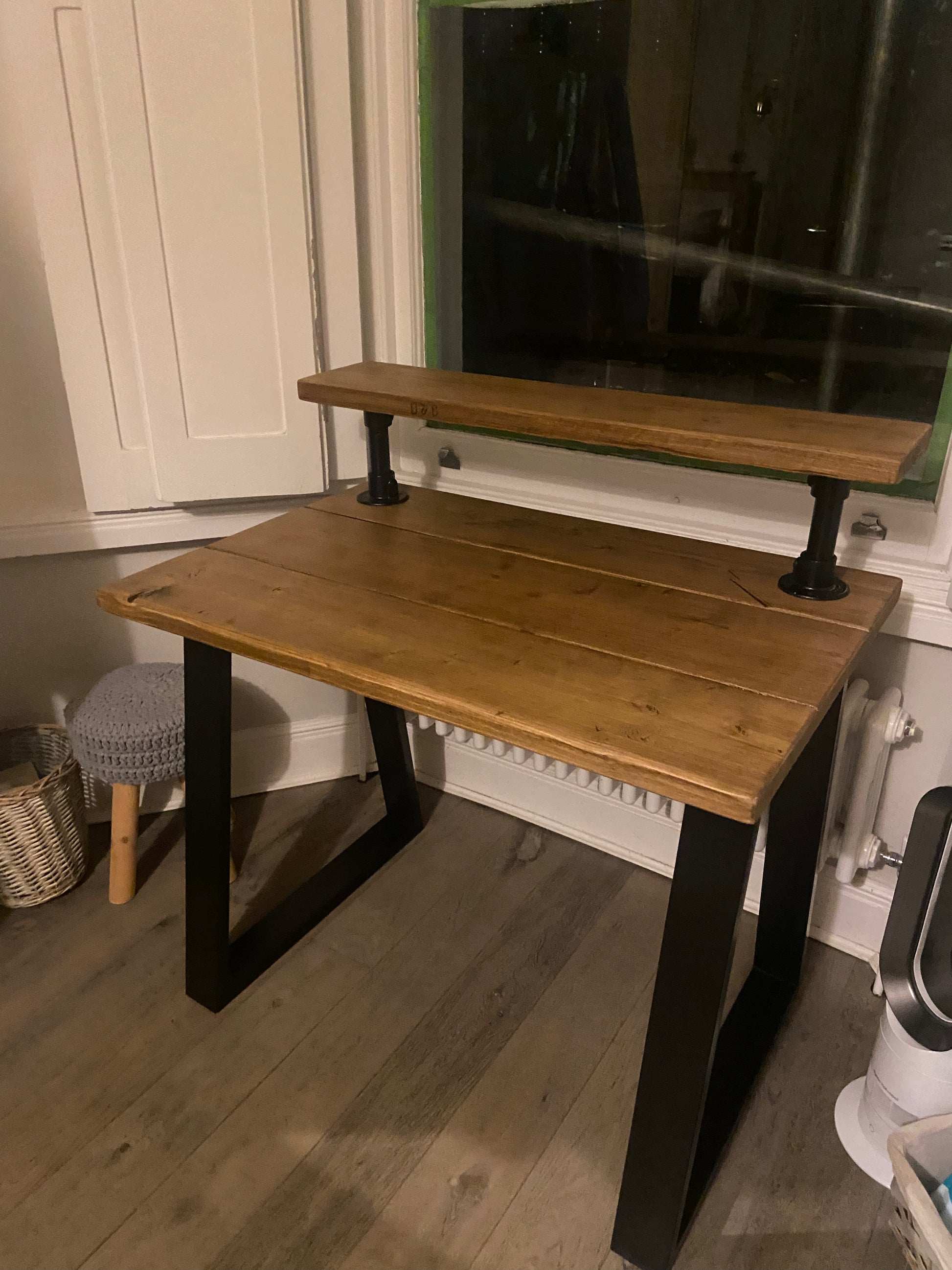 Handmade industrial desk with monitor shelf crafted from reclaimed wood and steel legs – rustic and modern workspace design.
