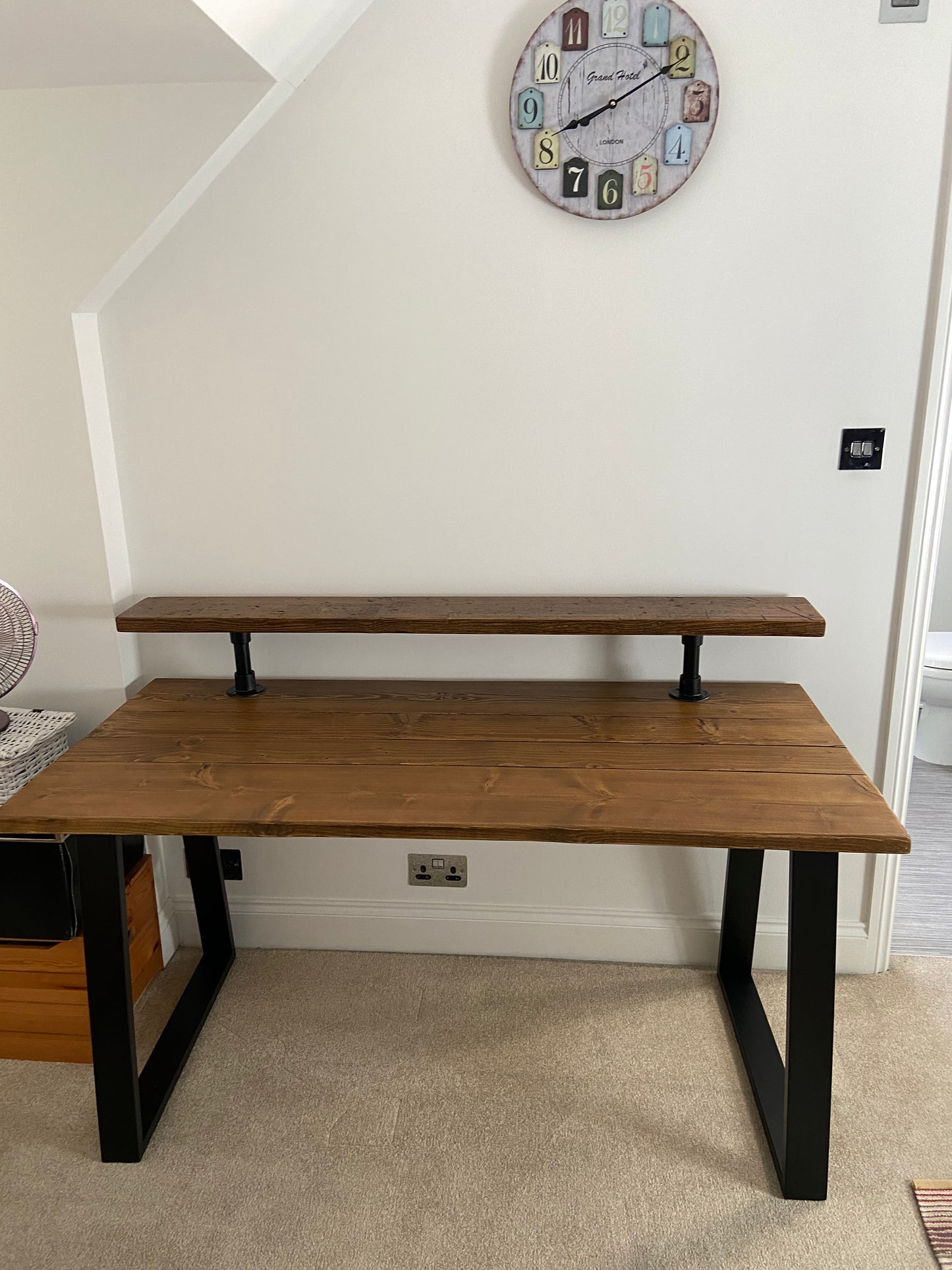 Handmade industrial desk with monitor shelf crafted from reclaimed wood and steel legs – rustic and modern workspace design.