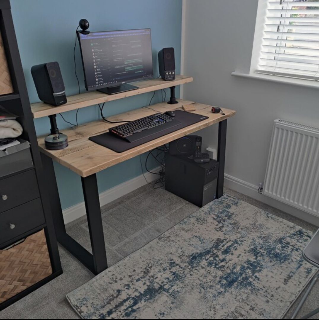 Handmade industrial desk with monitor shelf crafted from reclaimed wood and steel legs – rustic and modern workspace design.