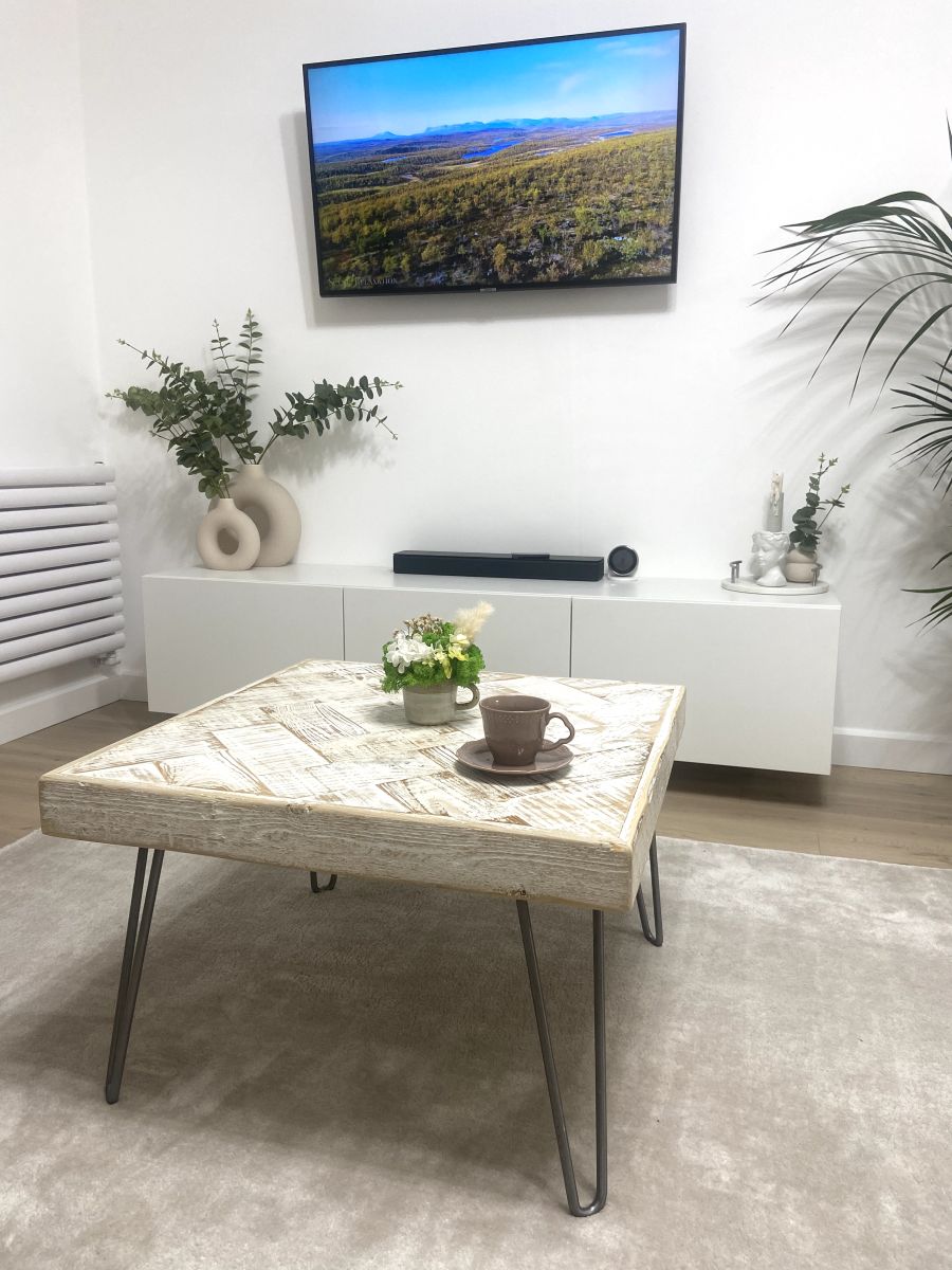 Handmade double herringbone coffee table with distressed reclaimed wood top and metal legs – rustic and bold living room centerpiece