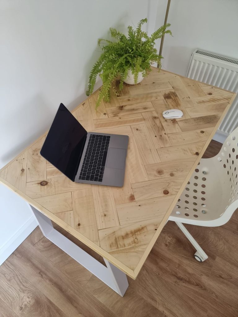Handcrafted desk with double herringbone reclaimed wood top and industrial metal legs – rustic yet modern design for home office or workspace.