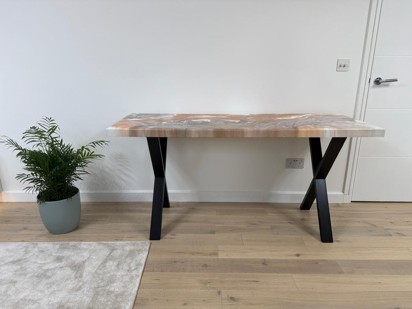 Handmade epoxy resin dining table with colourful pouring art design and custom metal legs – made to order in the UK.