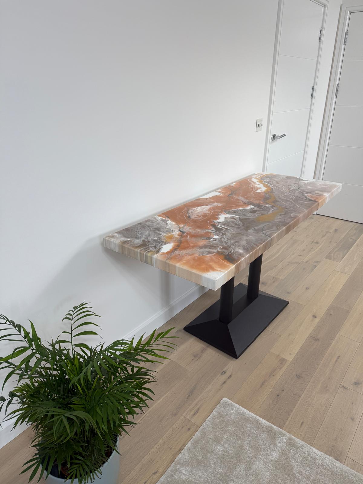 Handmade epoxy resin dining table with colourful pouring art design and custom metal legs – made to order in the UK.