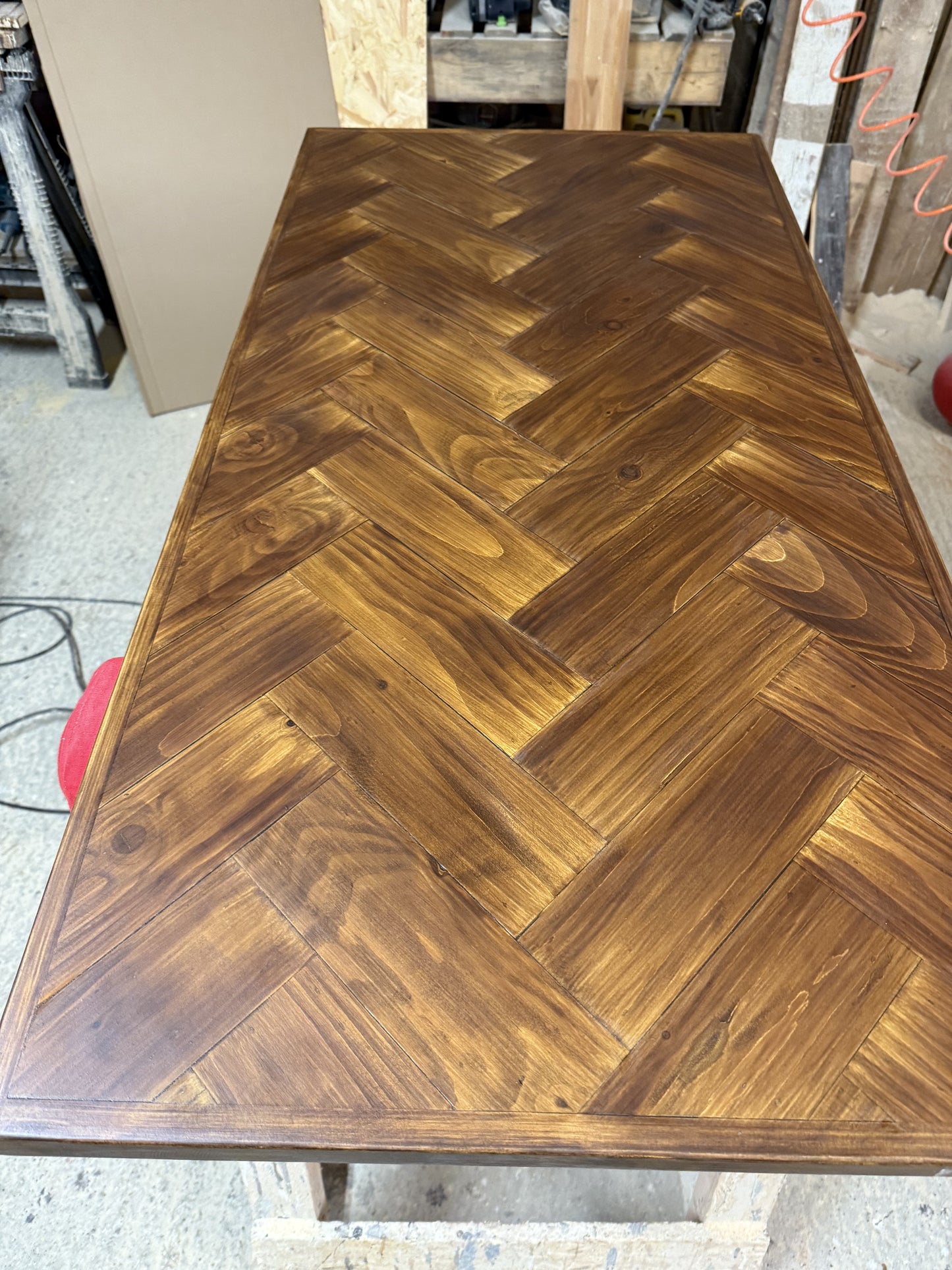 Handmade square bistro table with double herringbone reclaimed wood top and black cast iron pedestal base, finished with natural wax