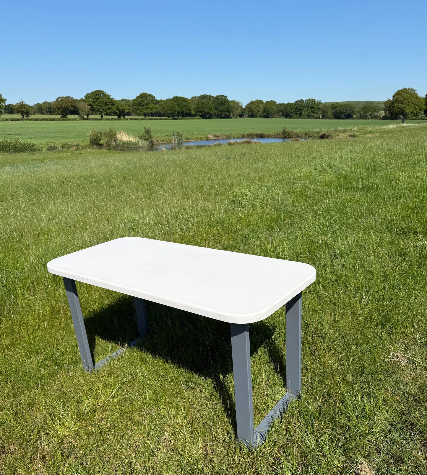 Handmade outdoor microcement dining table with white concrete-style top and matching benches – made to order in the UK, ideal for patios and terraces.