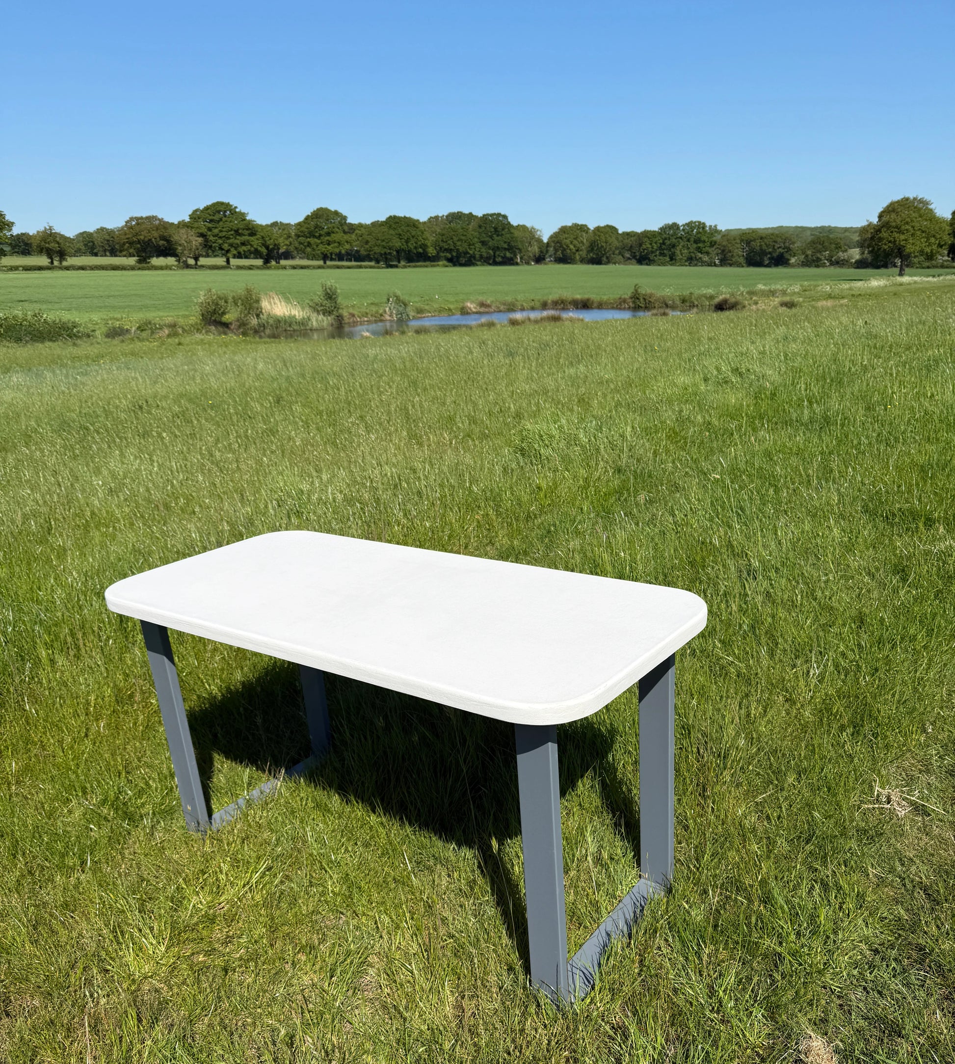 Handmade outdoor microcement dining table with white concrete-style top and matching benches – made to order in the UK, ideal for patios and terraces.