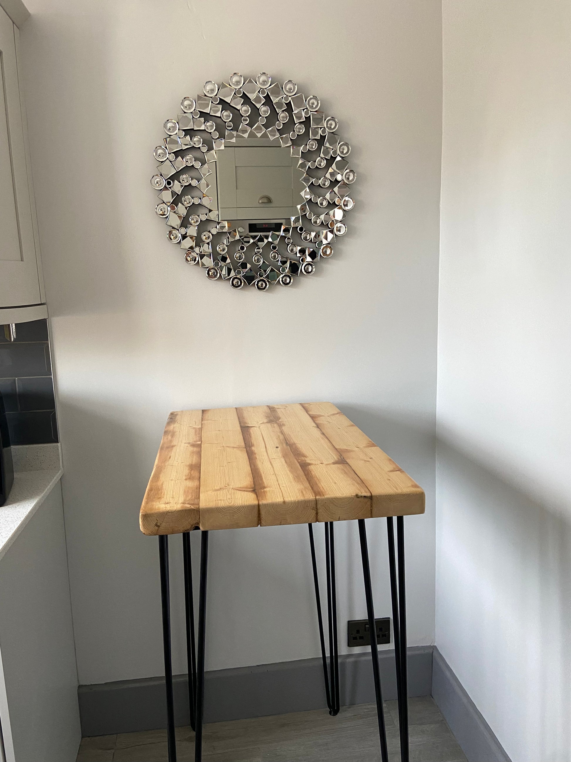 Handcrafted reclaimed wood breakfast bar made from aged joists, featuring natural imperfections, a smooth wax finish, and 90cm high industrial metal legs