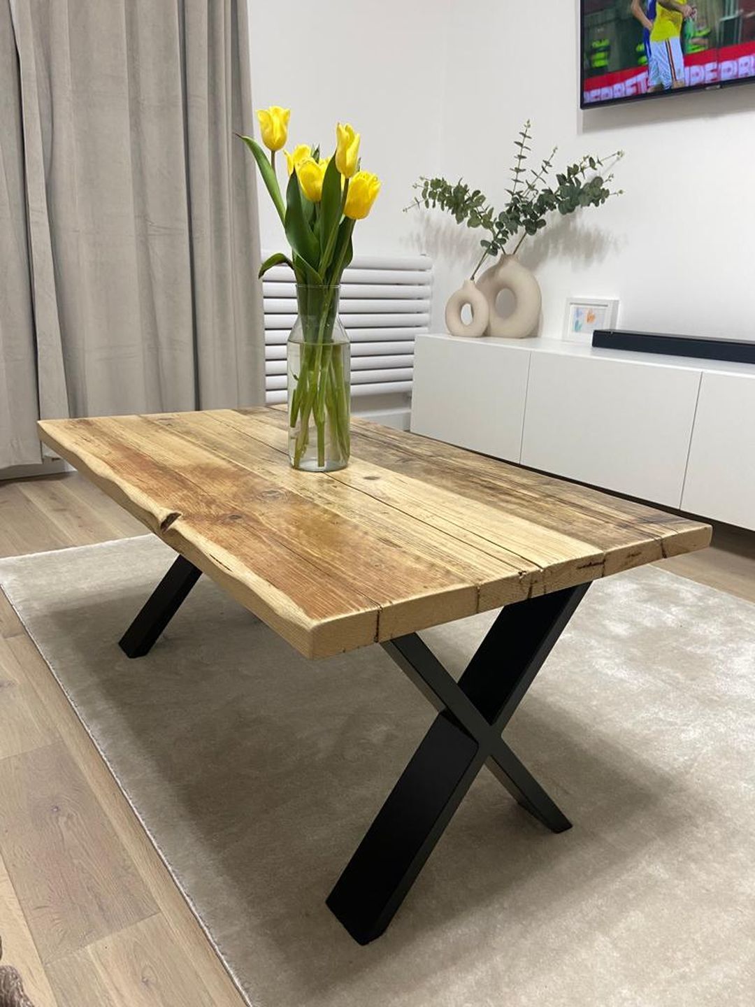 Handmade coffee table crafted from reclaimed scaffold boards with a rustic wood top and metal legs – sustainable and full of character.
