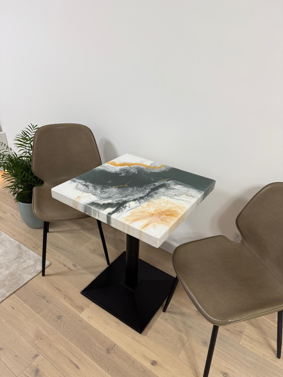 Handmade square epoxy resin dining table with artistic top and cast iron pedestal base – made to order in the UK.