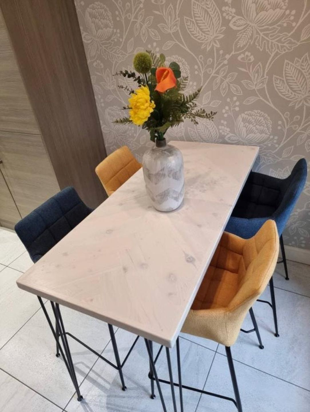 Handmade herringbone breakfast bar crafted from reclaimed wood with custom metal legs, made to order in the UK