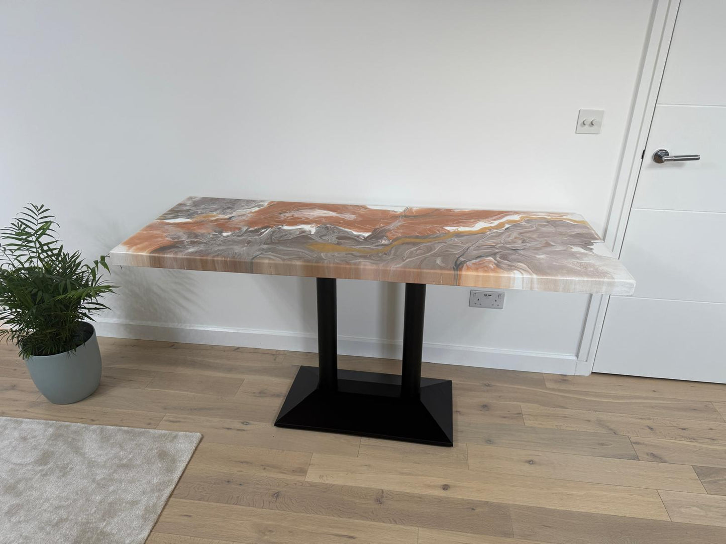Handmade epoxy resin dining table with colourful pouring art design and custom metal legs – made to order in the UK.