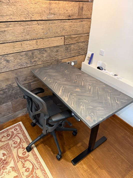 Adjustable height desk with reclaimed wood herringbone top and electric legs, featuring LED smart handset with memory presets and child lock – handcrafted sit-stand desk for home or office.