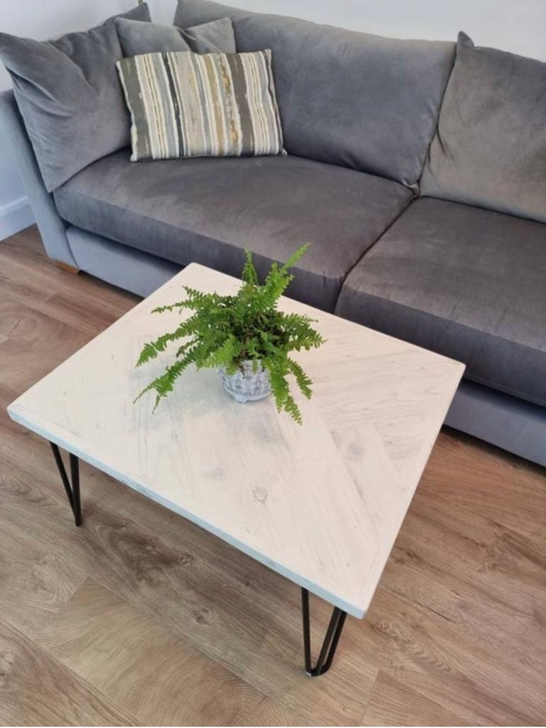 Handcrafted reclaimed wood coffee table with herringbone top and black metal legs – made to order in the UK.