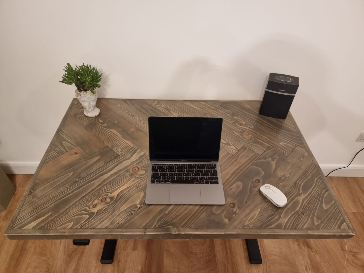 Adjustable height desk with reclaimed wood herringbone top and electric legs, featuring LED smart handset with memory presets and child lock – handcrafted sit-stand desk for home or office.