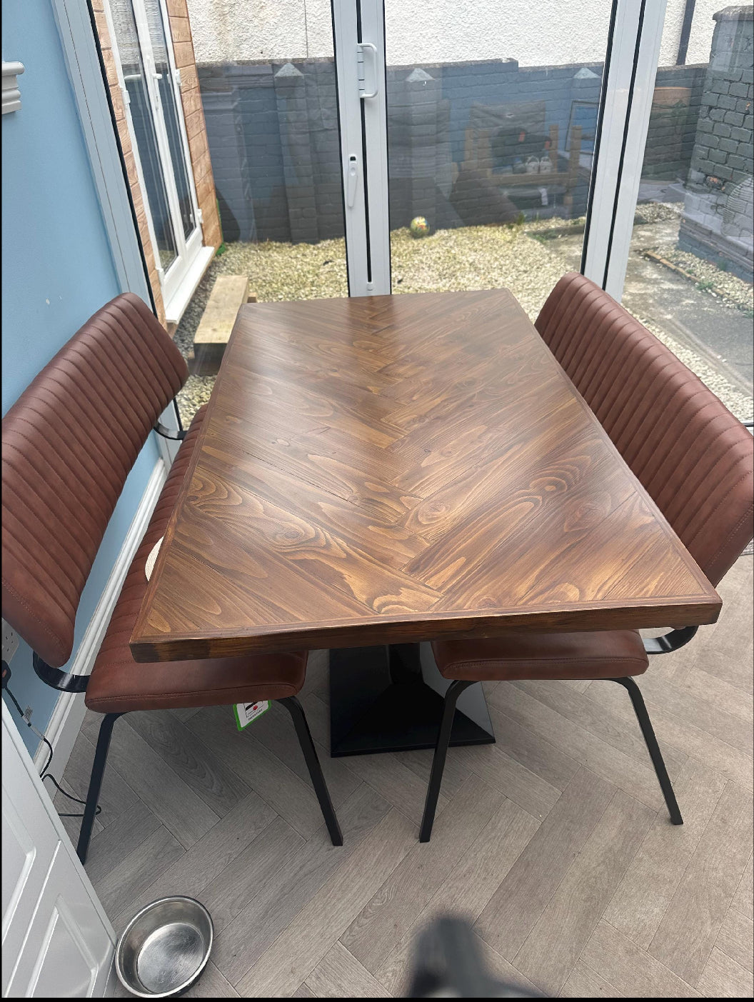 Handcrafted herringbone dining table made from reclaimed wood