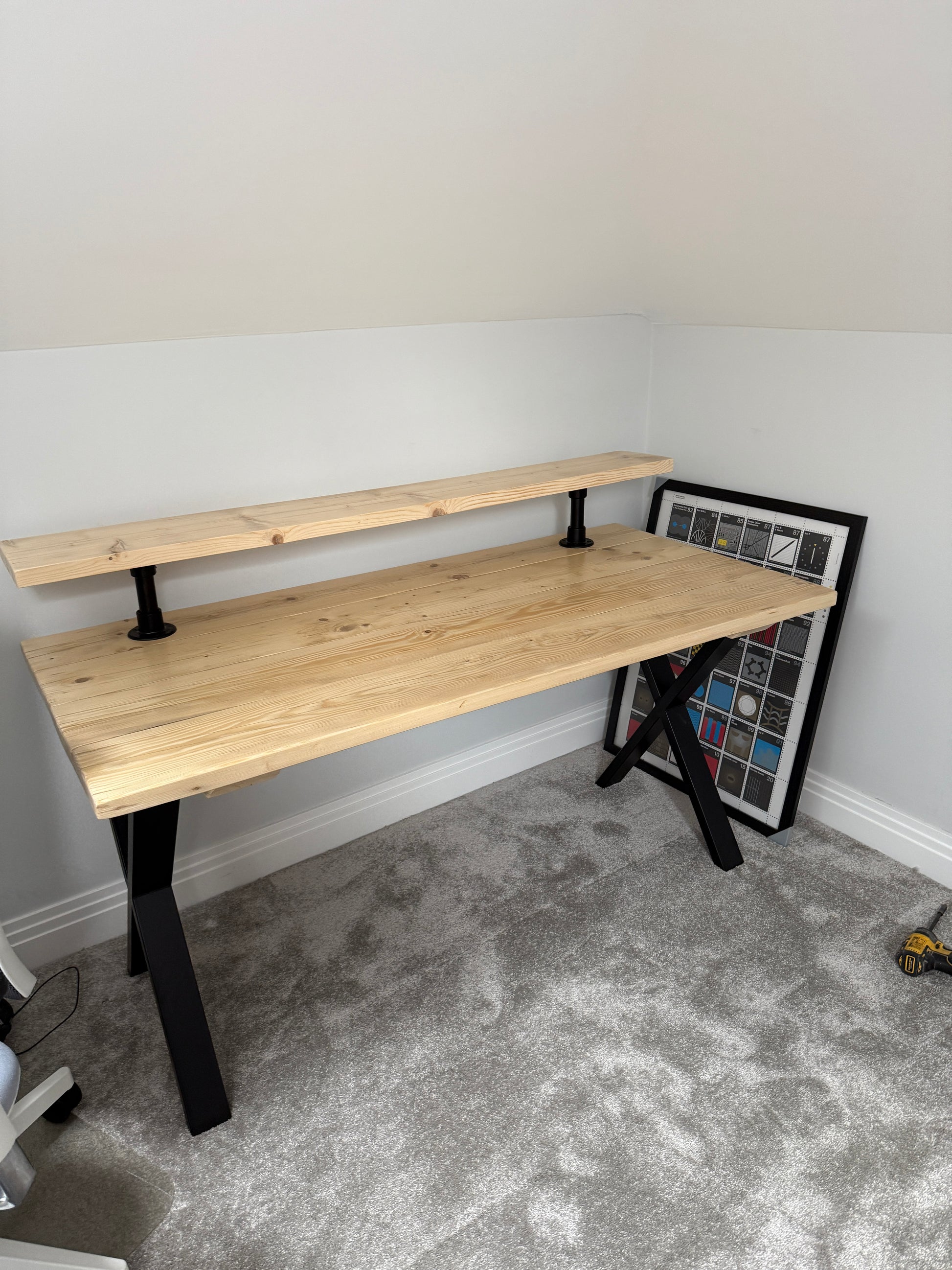 Handmade industrial desk with monitor shelf crafted from reclaimed wood and steel legs – rustic and modern workspace design.
