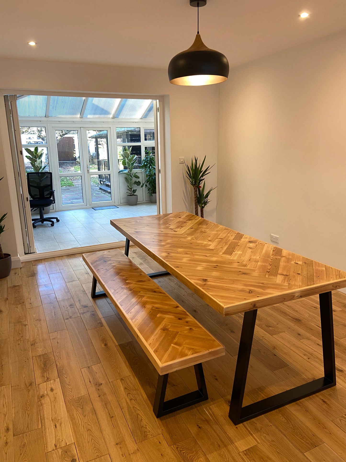Handmade herringbone table crafted from reclaimed wood with metal legs, made to order in the UK
