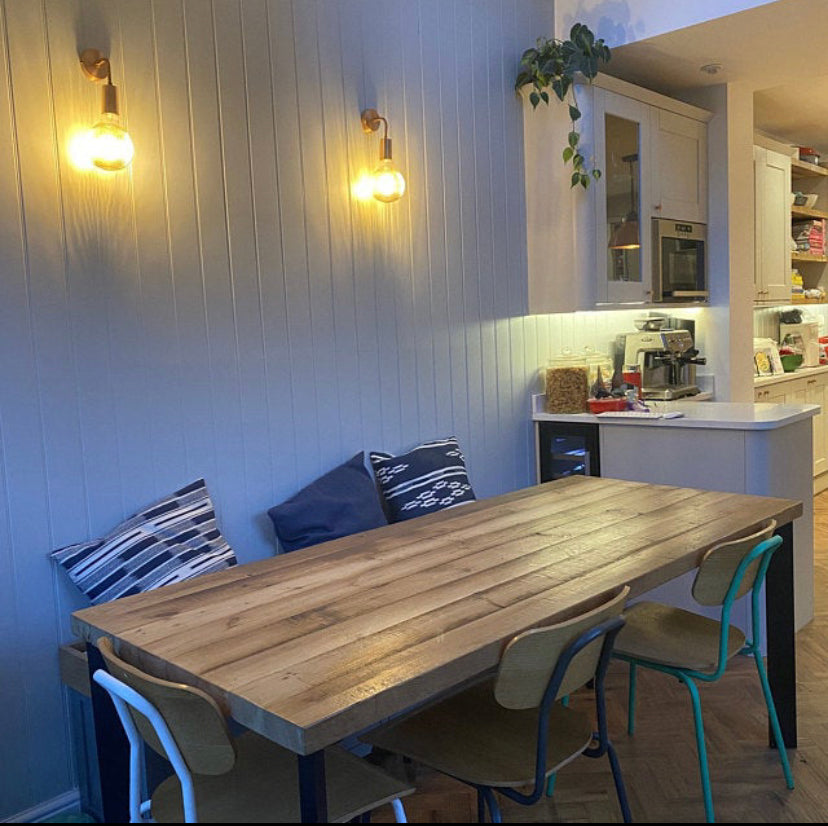 Reclaimed wood dining table with matching benches tucked underneath – rustic industrial style furniture set