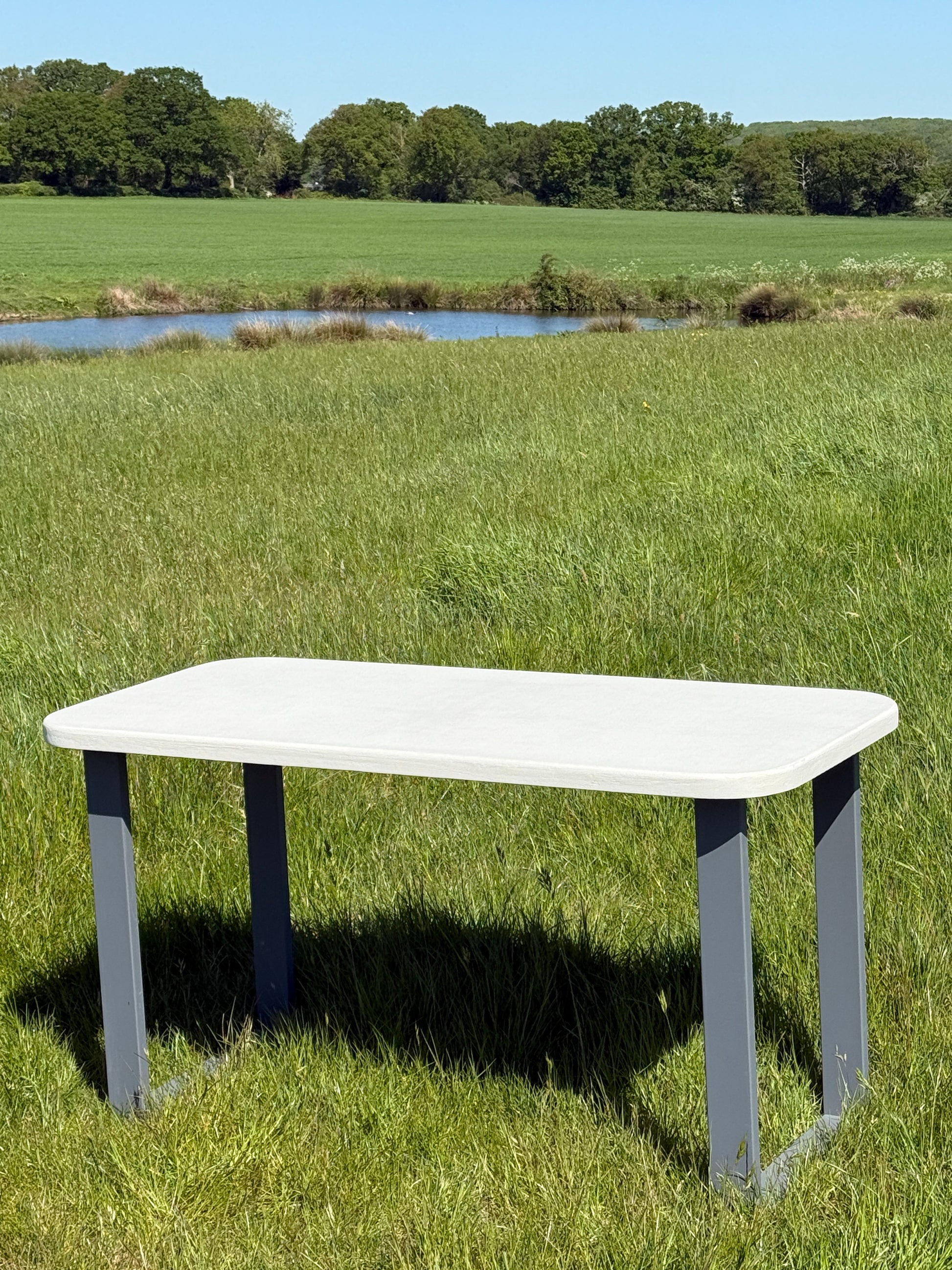 Handmade outdoor microcement dining table with white concrete-style top and matching benches – made to order in the UK, ideal for patios and terraces.