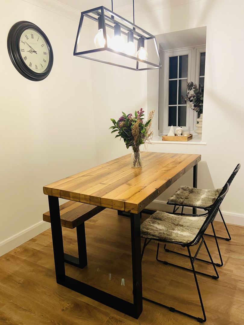 Reclaimed wood dining table with matching benches tucked underneath – rustic industrial style furniture set