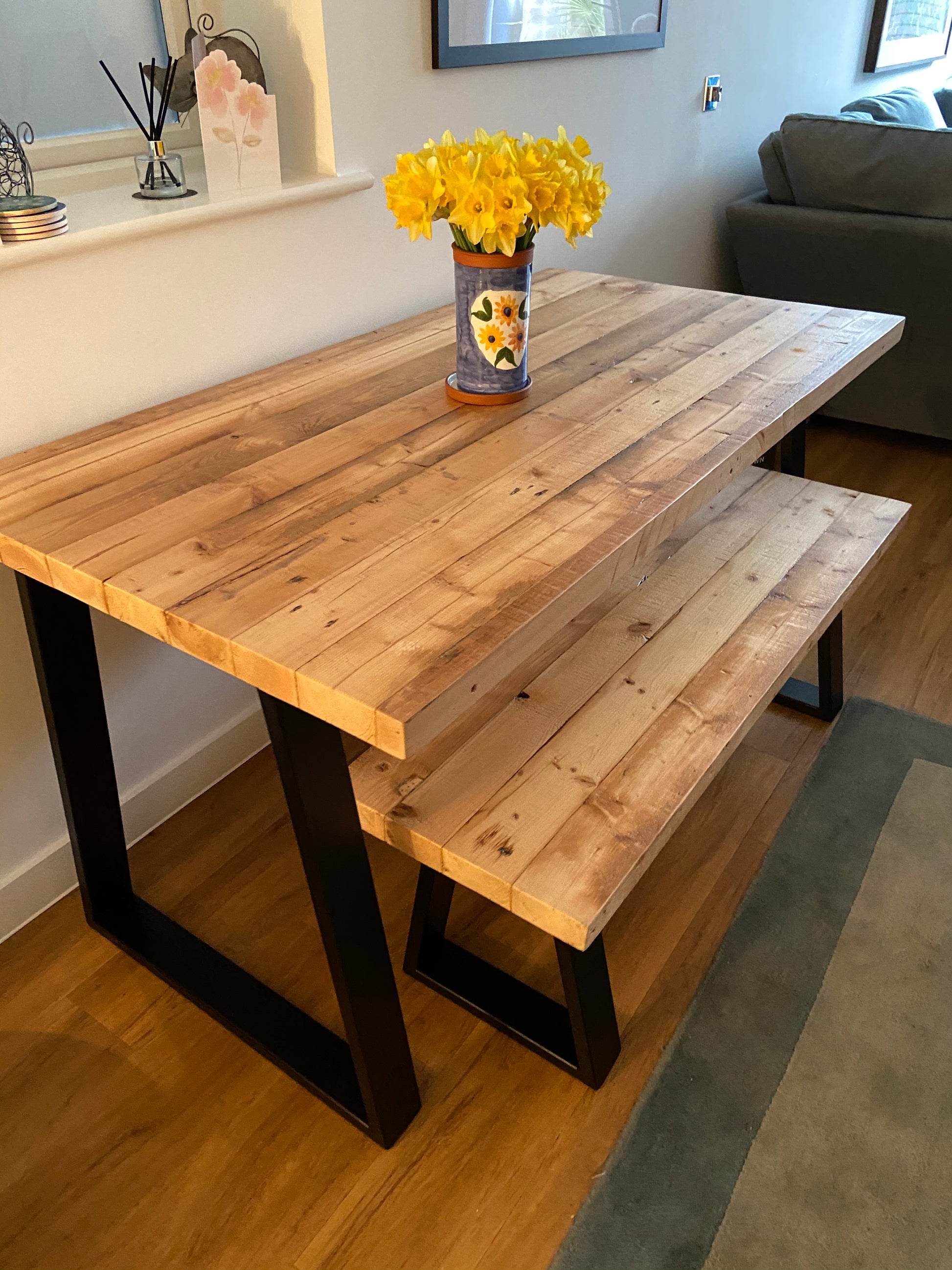 Reclaimed wood dining table with matching benches tucked underneath – rustic industrial style furniture set
