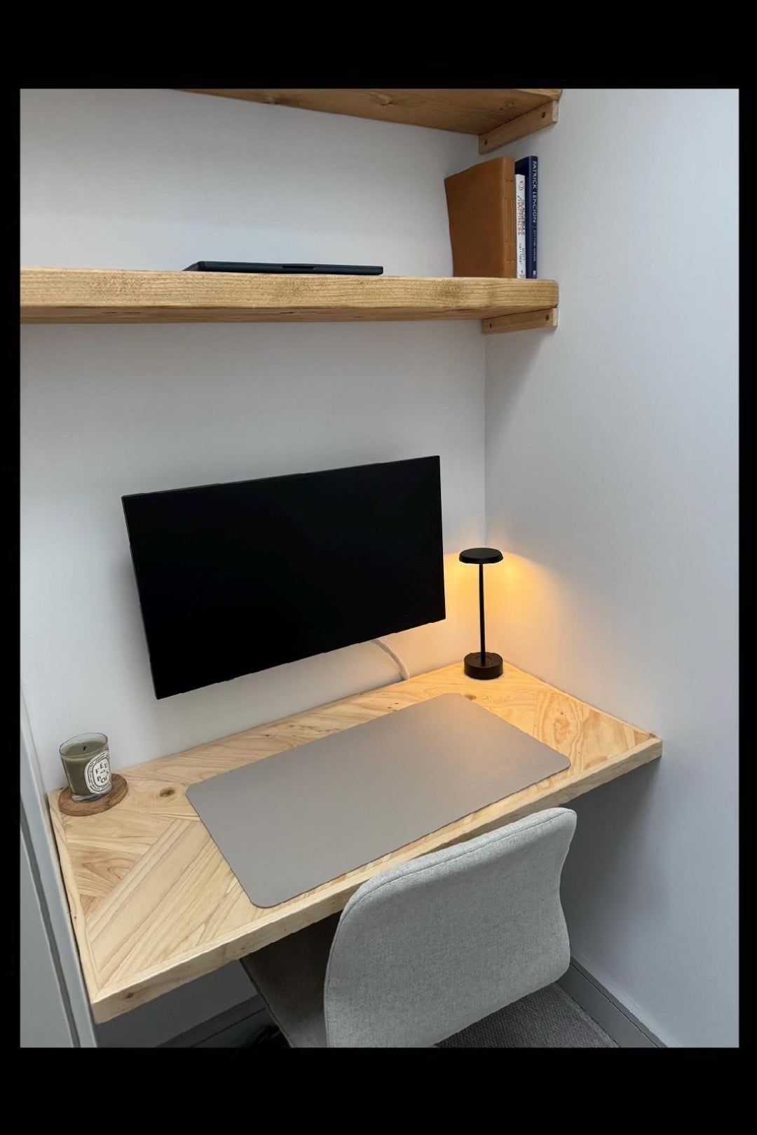 Reclaimed wood desk with herringbone top and black industrial metal legs, featuring a smooth wax finish and natural wood variations