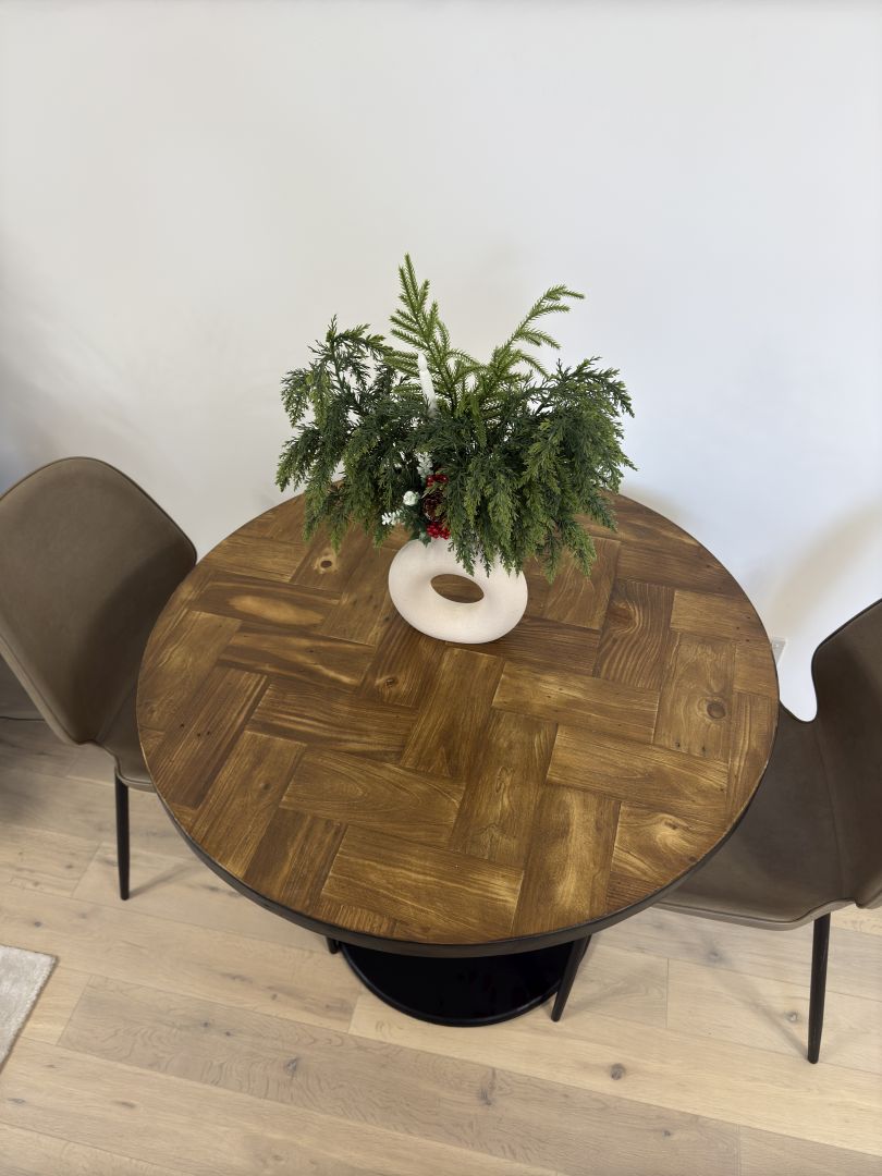 Handmade round reclaimed wood dining table with double herringbone pattern, smooth sanded top, and natural wax finish – rustic and elegant UK craftsmanship