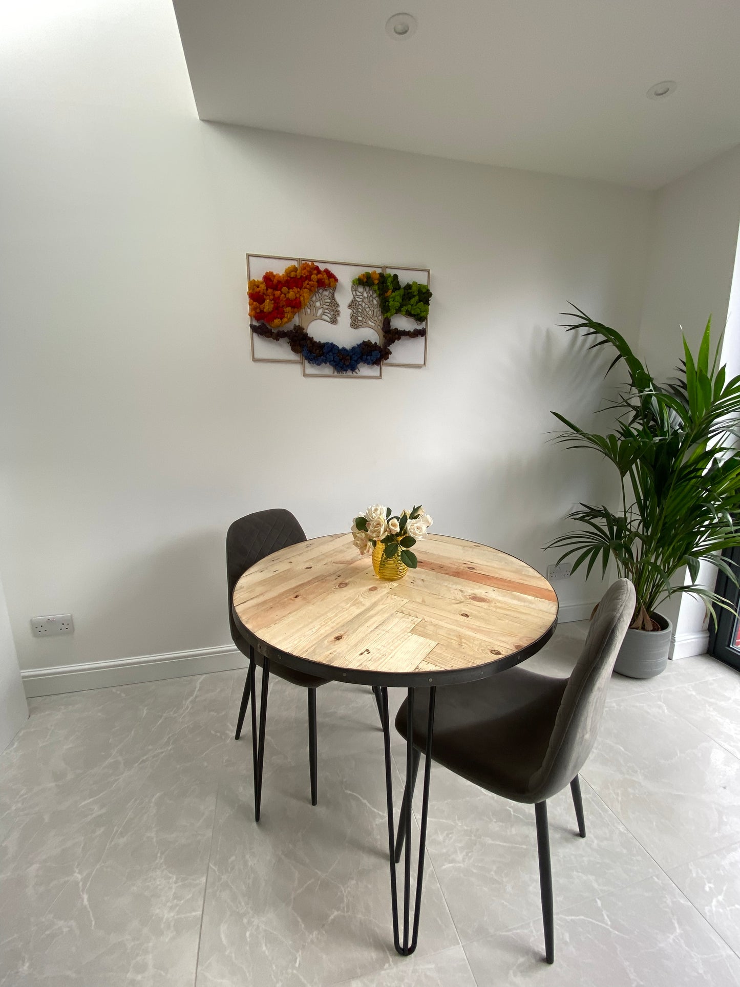 Handmade round reclaimed wood dining table with double herringbone pattern, smooth sanded top, and natural wax finish – rustic and elegant UK craftsmanship