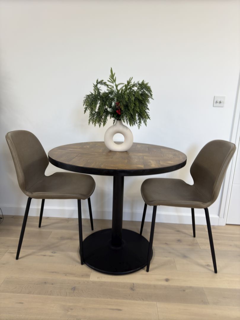 Handmade round reclaimed wood dining table with double herringbone pattern, smooth sanded top, and natural wax finish – rustic and elegant UK craftsmanship