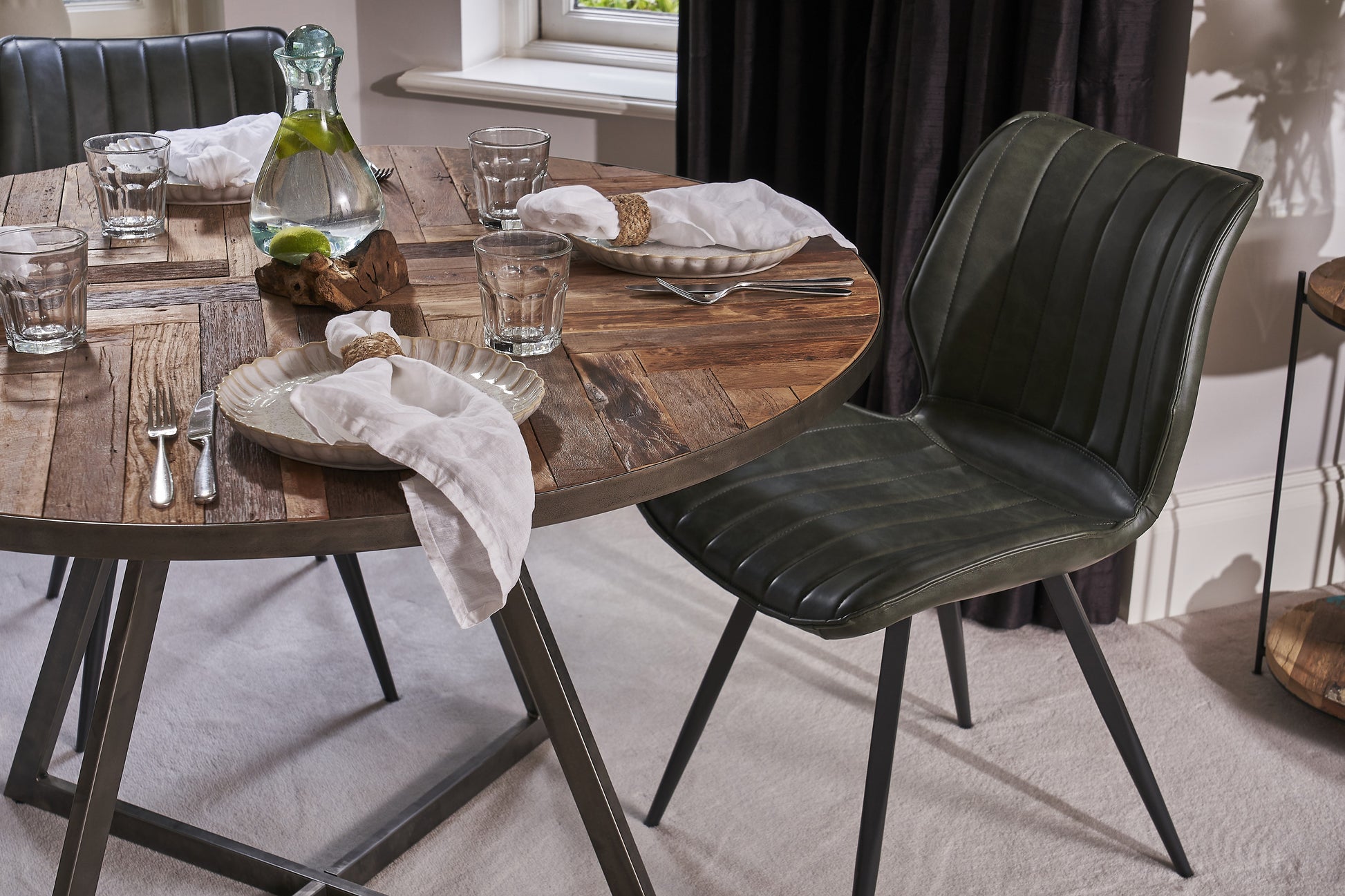 Round reclaimed wood dining table with sealed steel legs in rustic industrial style – Dockhouse Series