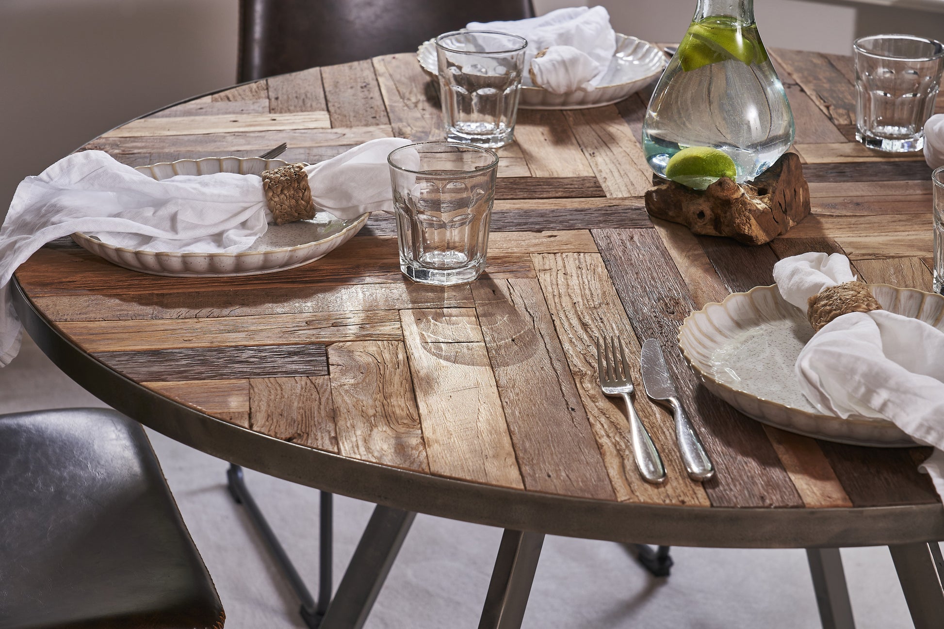 Round reclaimed wood dining table with sealed steel legs in rustic industrial style – Dockhouse Series