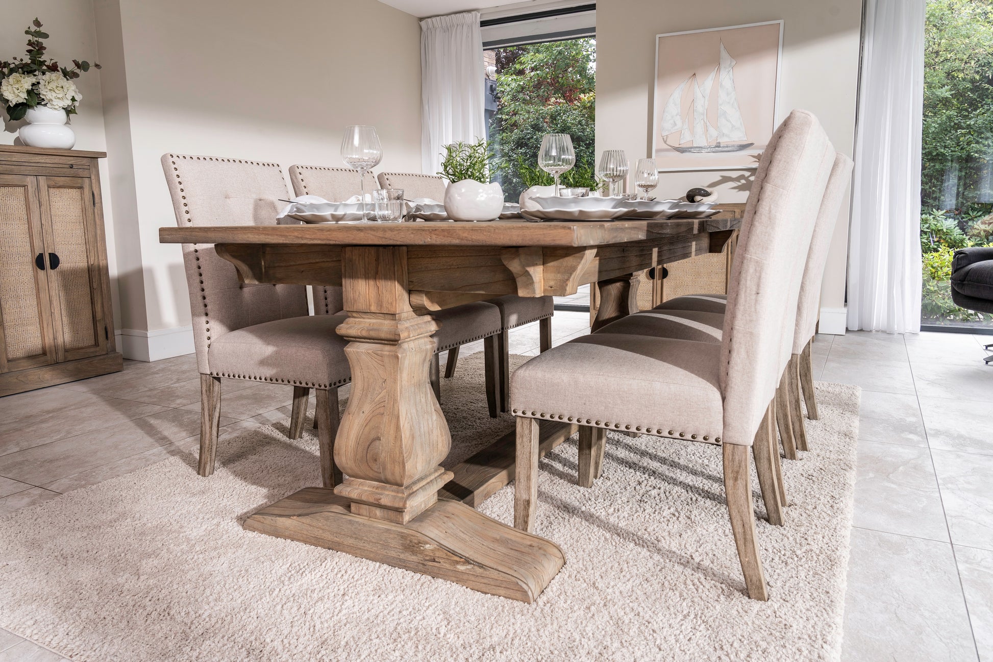 Solid oak extending dining table with pedestal base, shown styled in a neutral dining room. Part of the Elmstead Series by TheRoughWood.