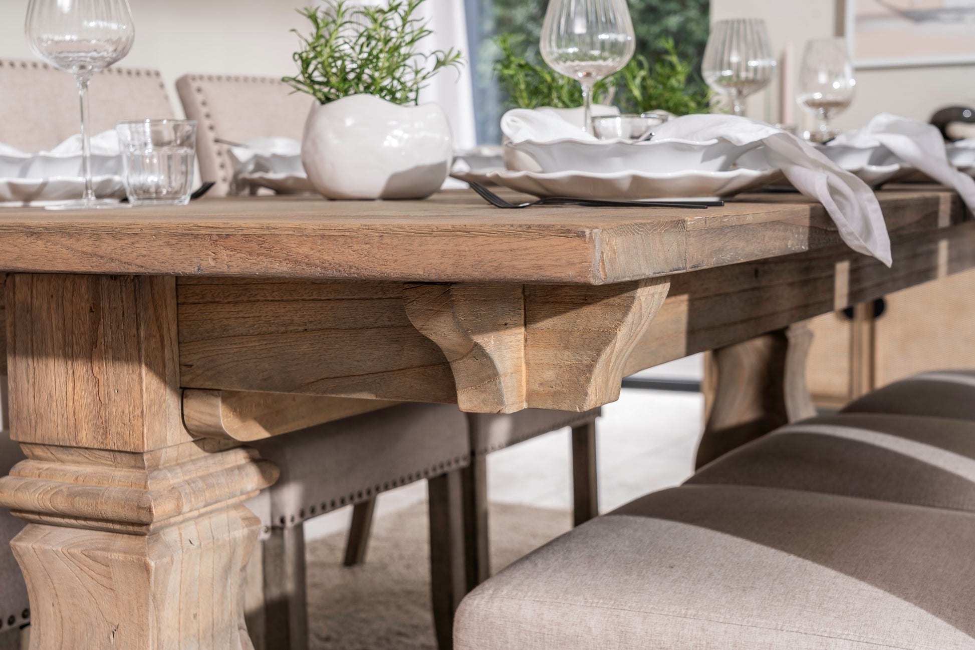 Solid oak extending dining table with pedestal base, shown styled in a neutral dining room. Part of the Elmstead Series by TheRoughWood.