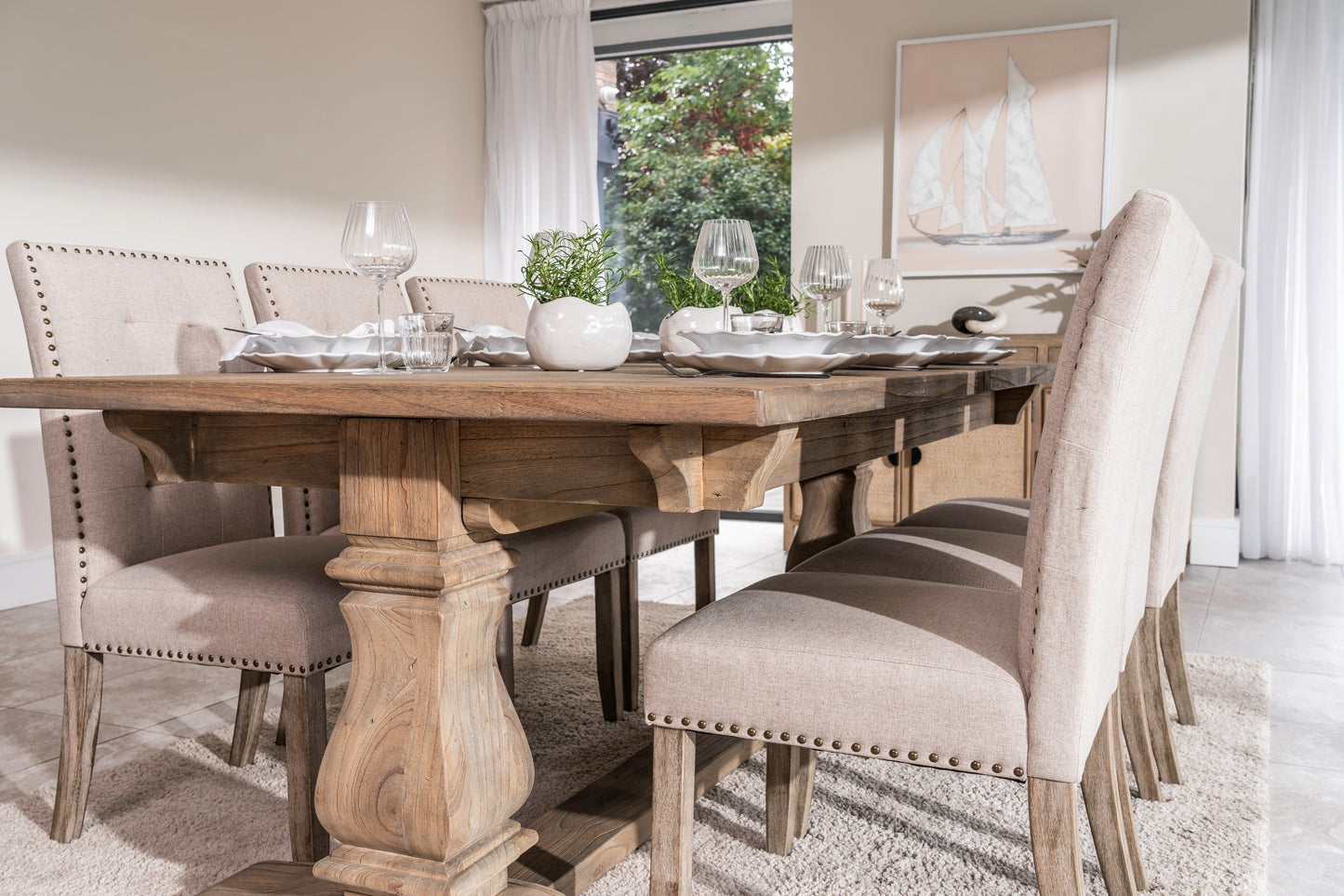 Solid oak extending dining table with pedestal base, shown styled in a neutral dining room. Part of the Elmstead Series by TheRoughWood.