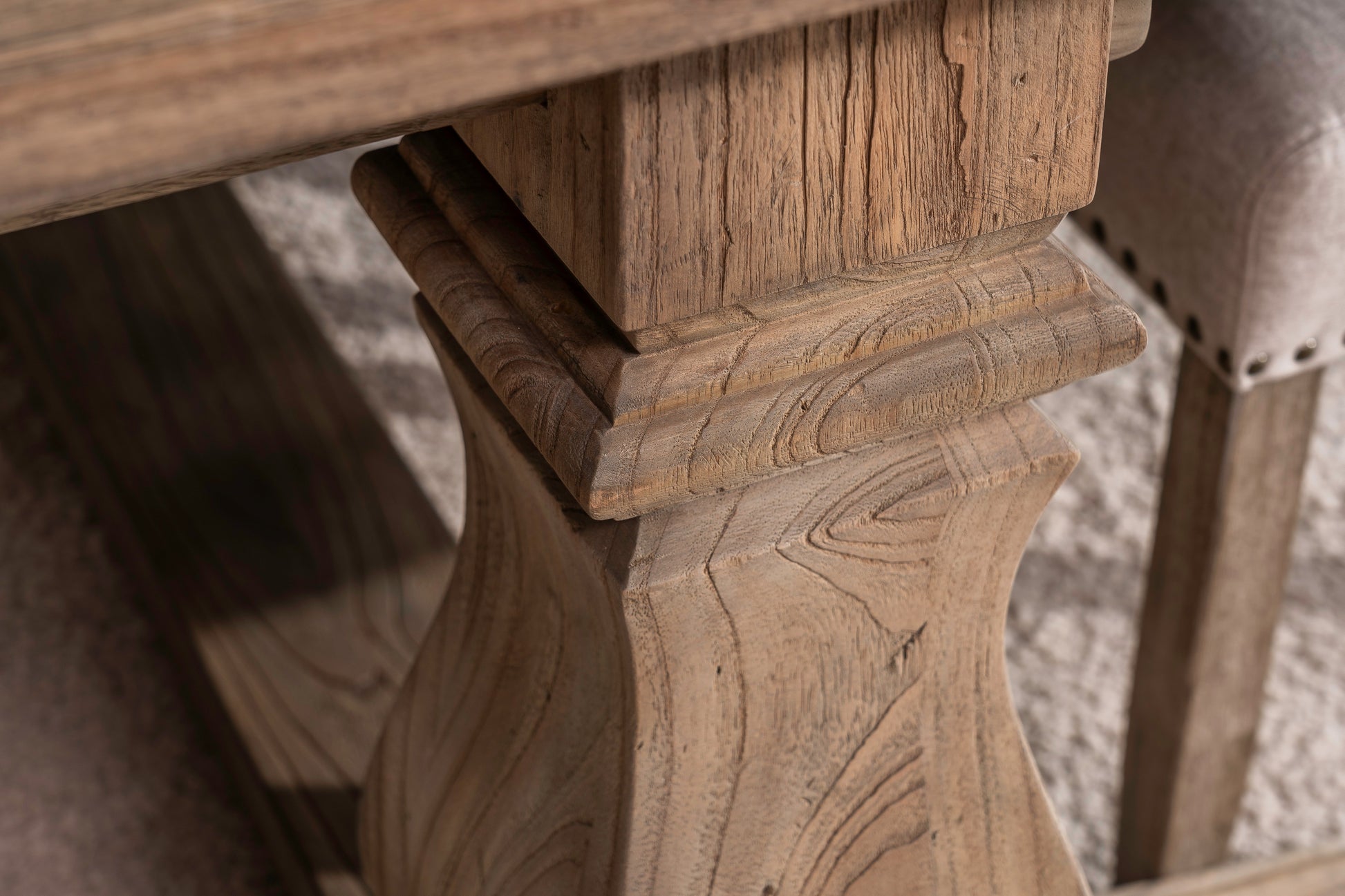 Solid oak extending dining table with pedestal base, shown styled in a neutral dining room. Part of the Elmstead Series by TheRoughWood.