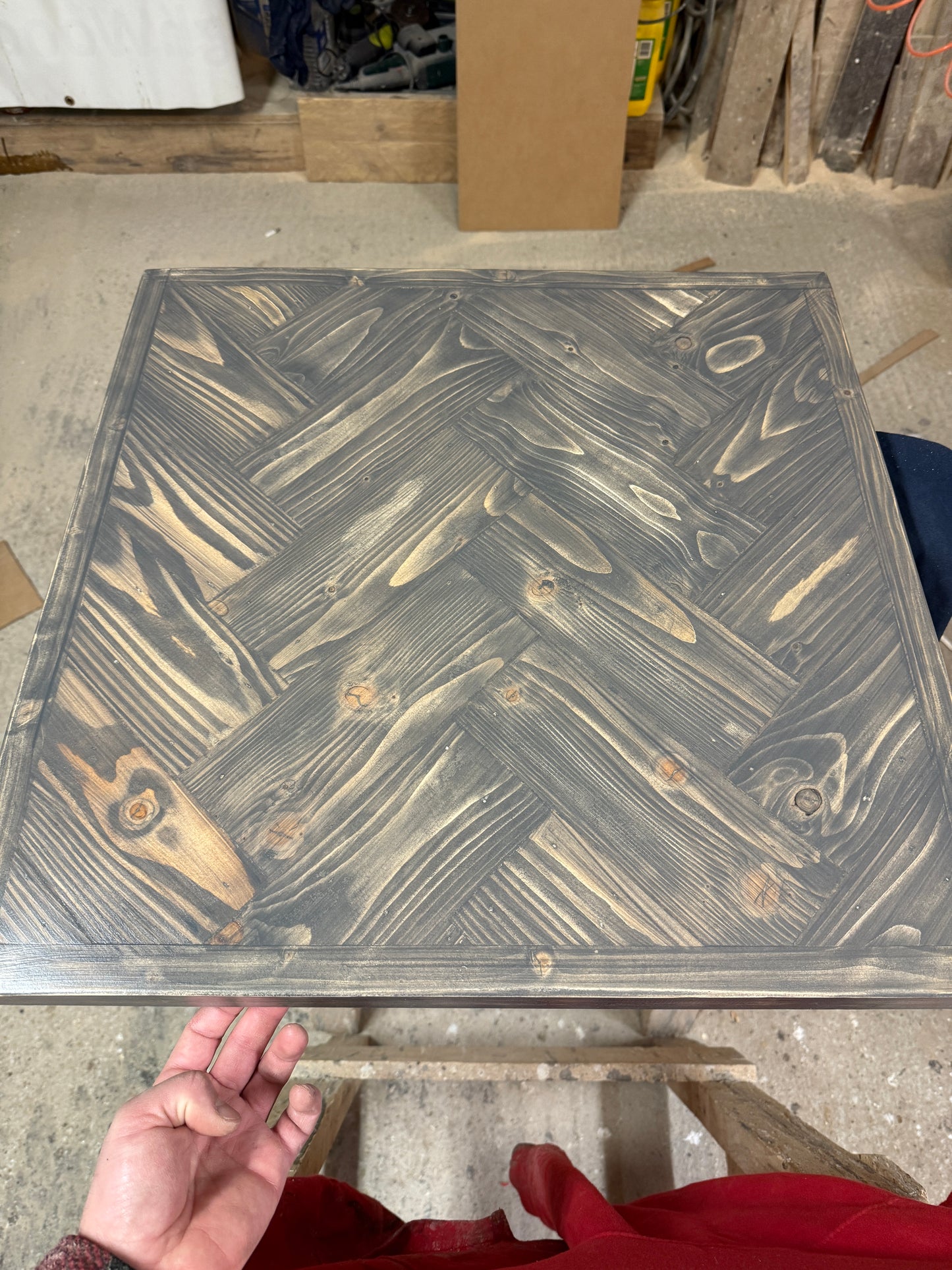 Handmade square bistro table with double herringbone reclaimed wood top and black cast iron pedestal base, finished with natural wax